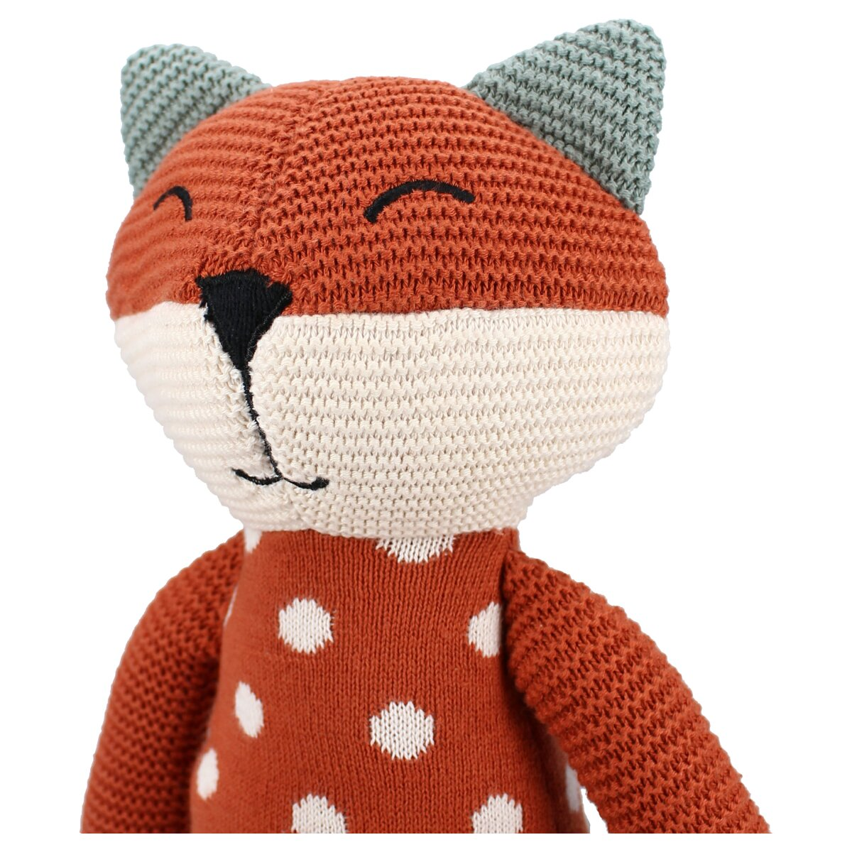 Ein Stofffuchs-Spielzeug. Es ist orange und weiß mit einem grünen Hut und weißen Punkten.