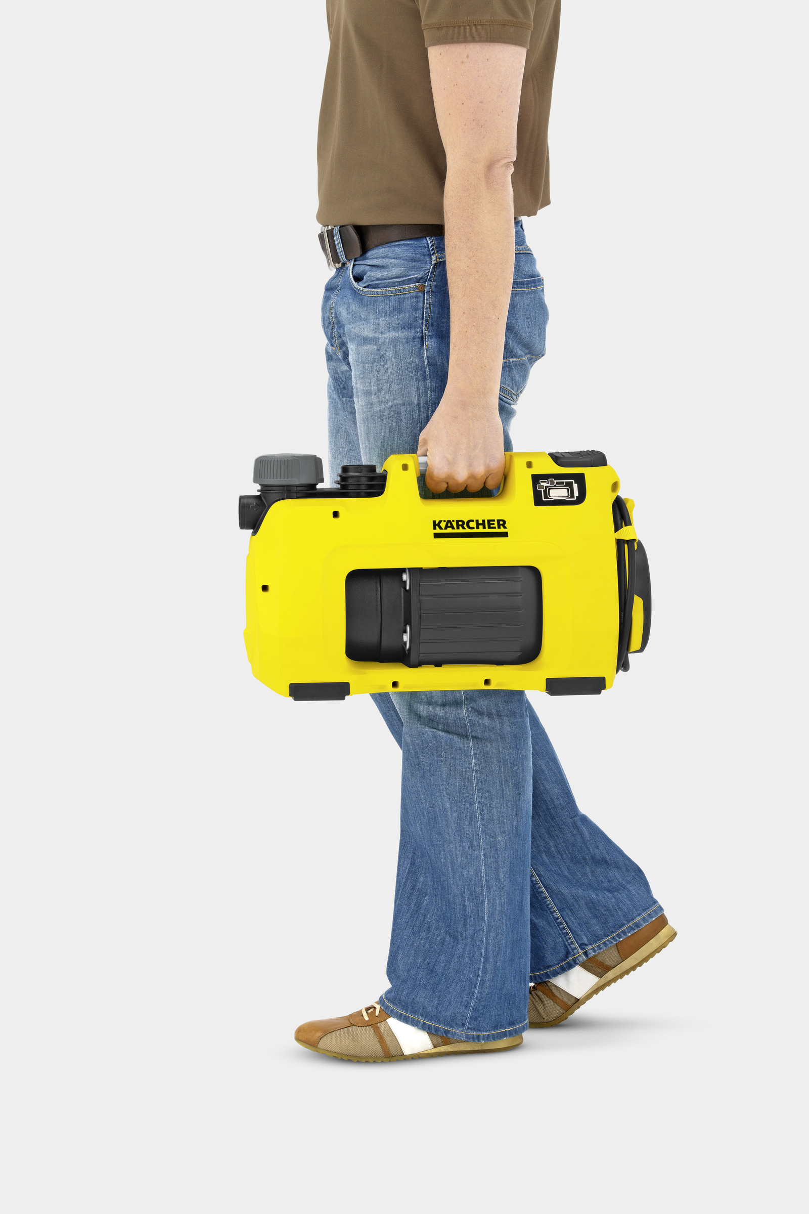 Mężczyzna trzymający żółtą pompę wodną Kärcher. Białe tło.