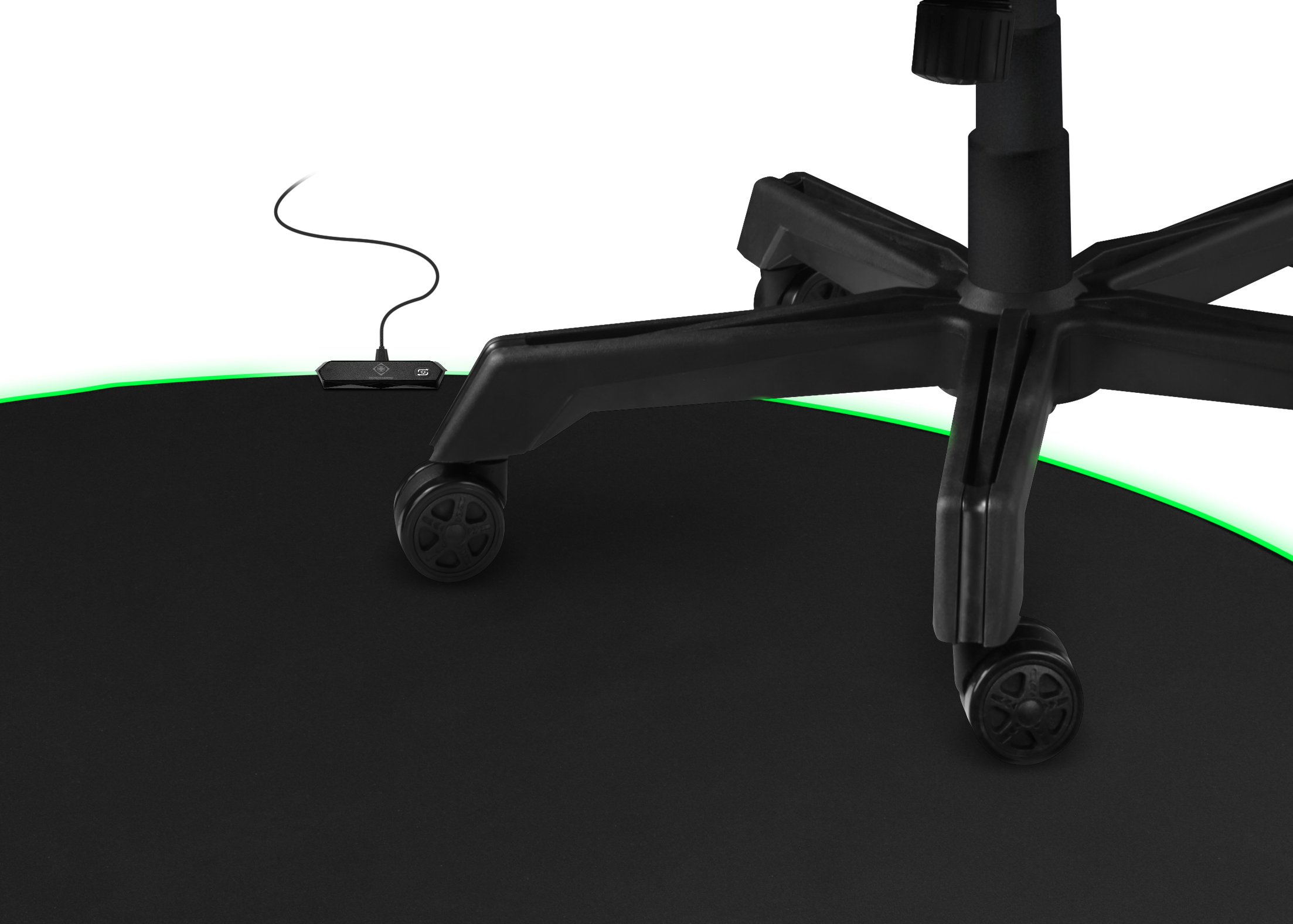 Black gaming desk mat with a green glowing edge, and a black chair.