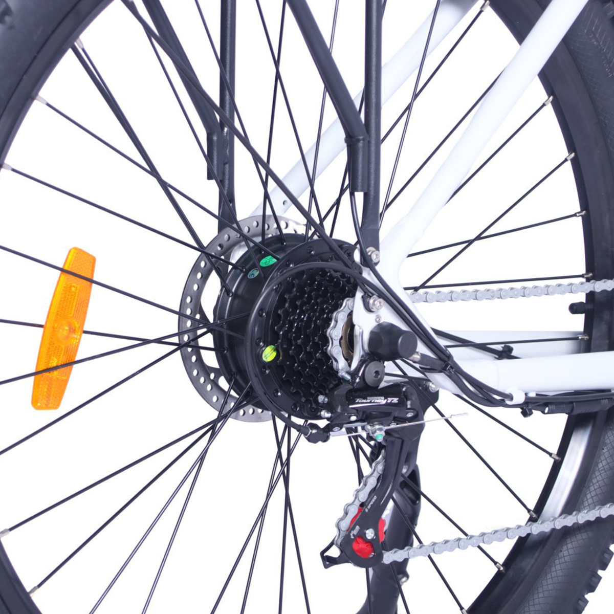 Zbliżenie koła roweru, tylny mechanizm, czarne szprychy, biała rama i pomarańczowy odblask.