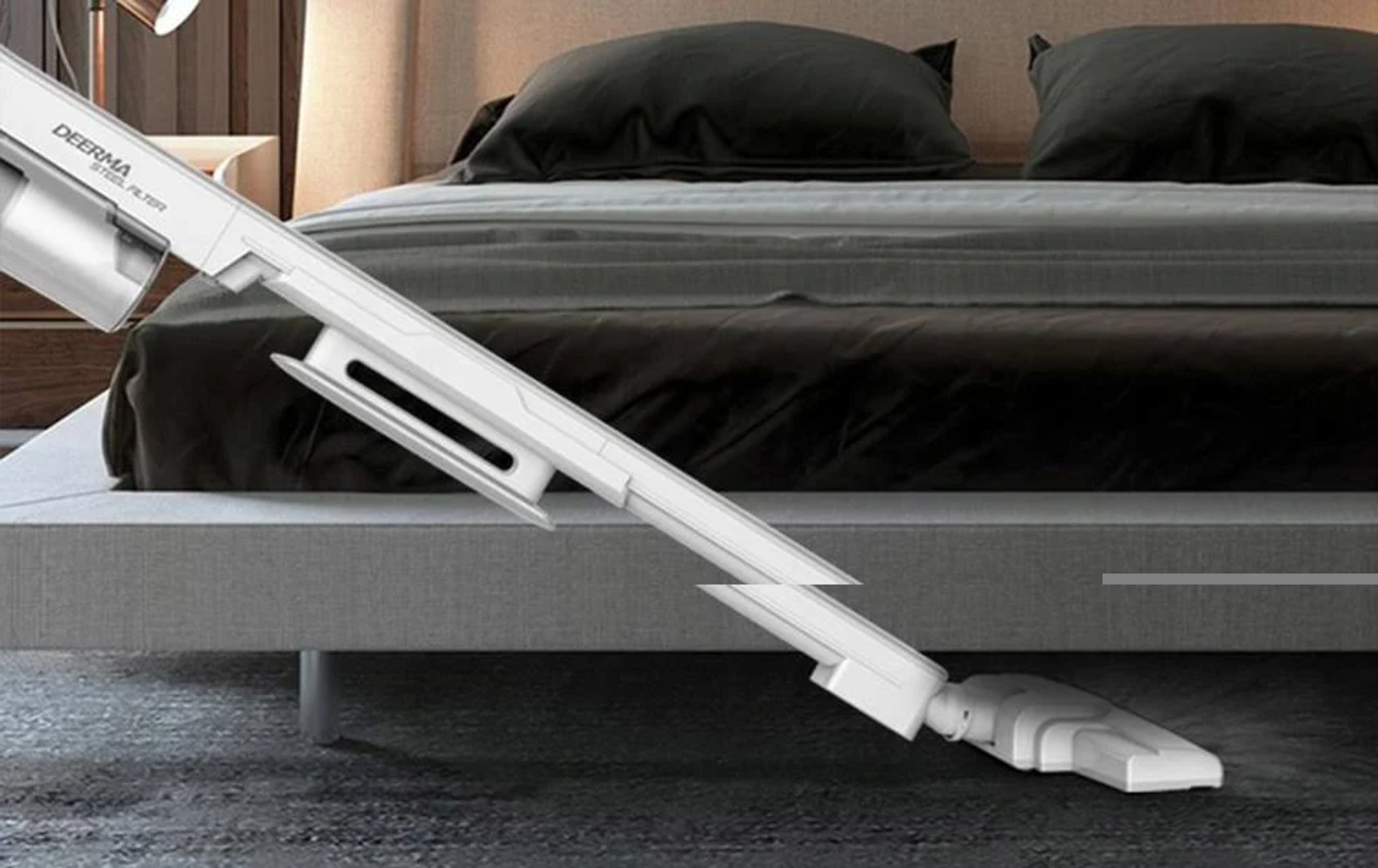 Biało-szara głowica odkurzacza czyszcząca szary dywan w sypialni.