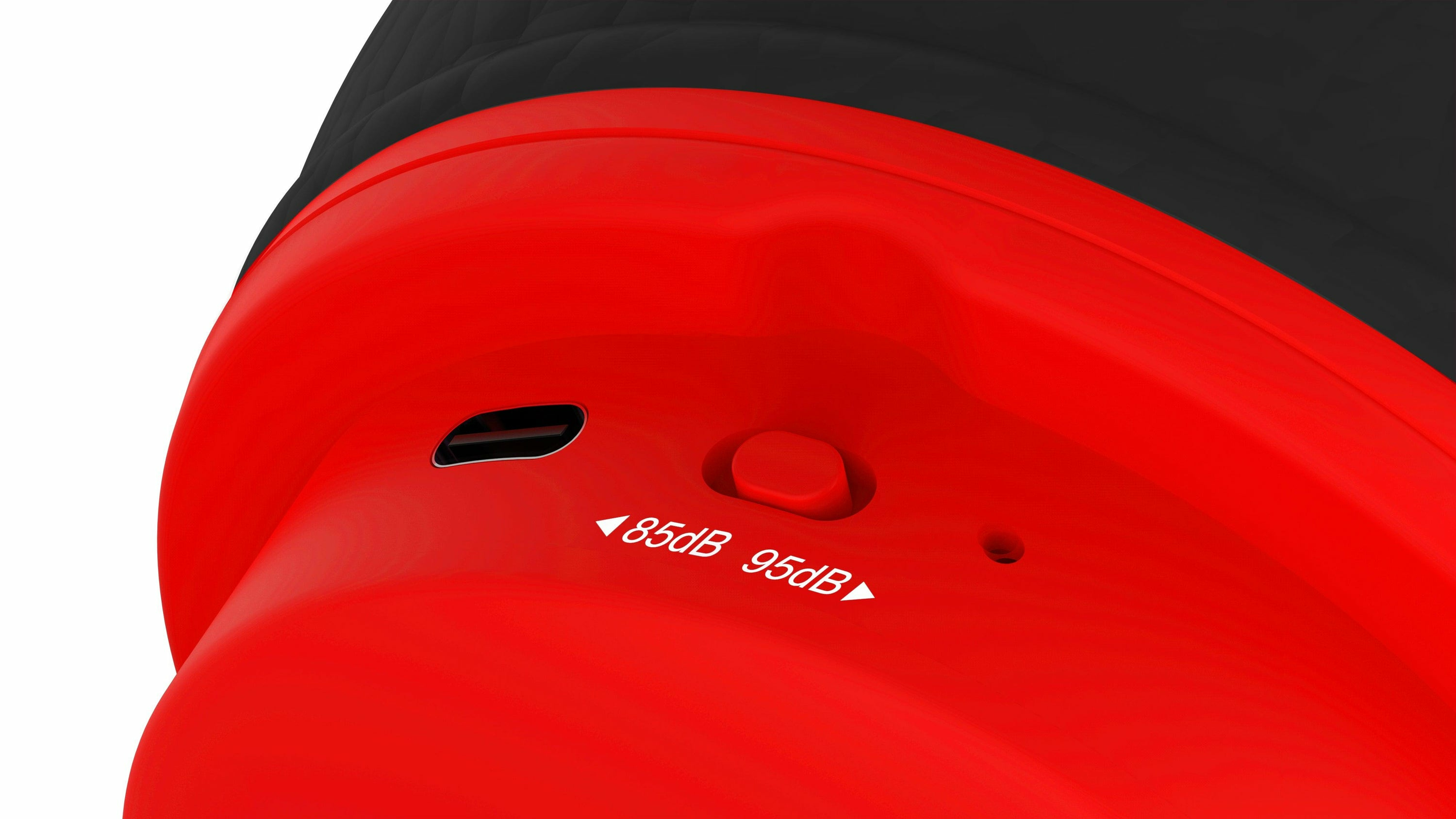 Zbliżenie czerwonego urządzenia z przyciskiem i tekstem pokazującym ustawienia 85dB i 95dB.