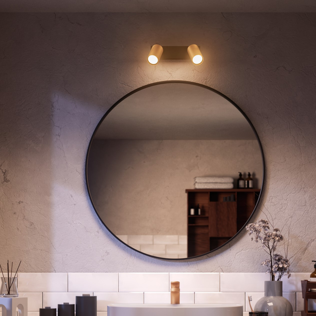Bathroom with a circular mirror, overhead lights, and a sink with accessories. A cabinet is in the background.
