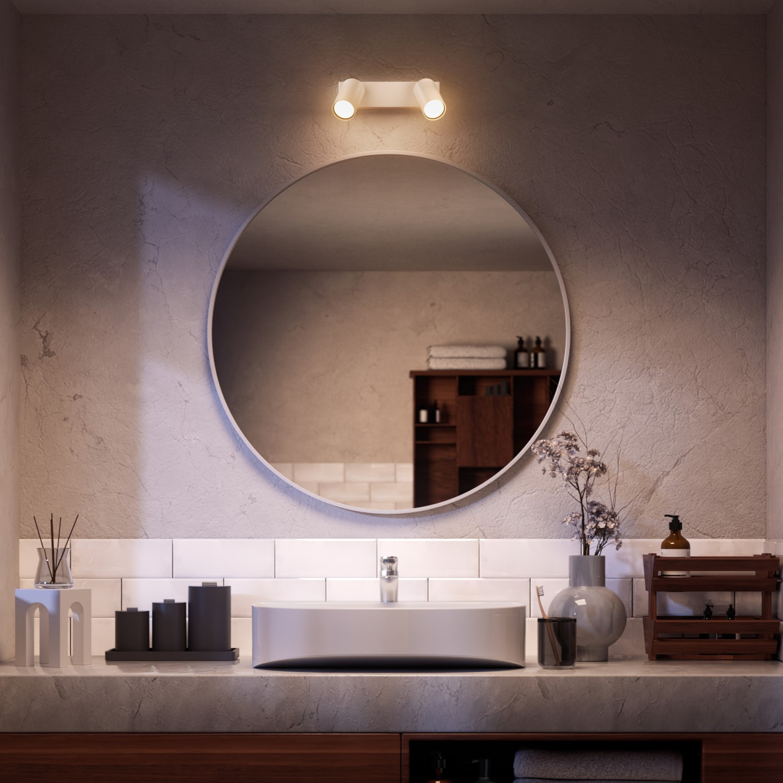 Bathroom with a circular mirror, overhead lights, and a sink with accessories. A cabinet is in the background.
