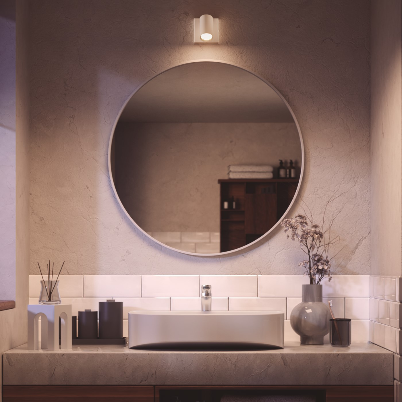 Bathroom interior with a round mirror, sink, and decorative items.