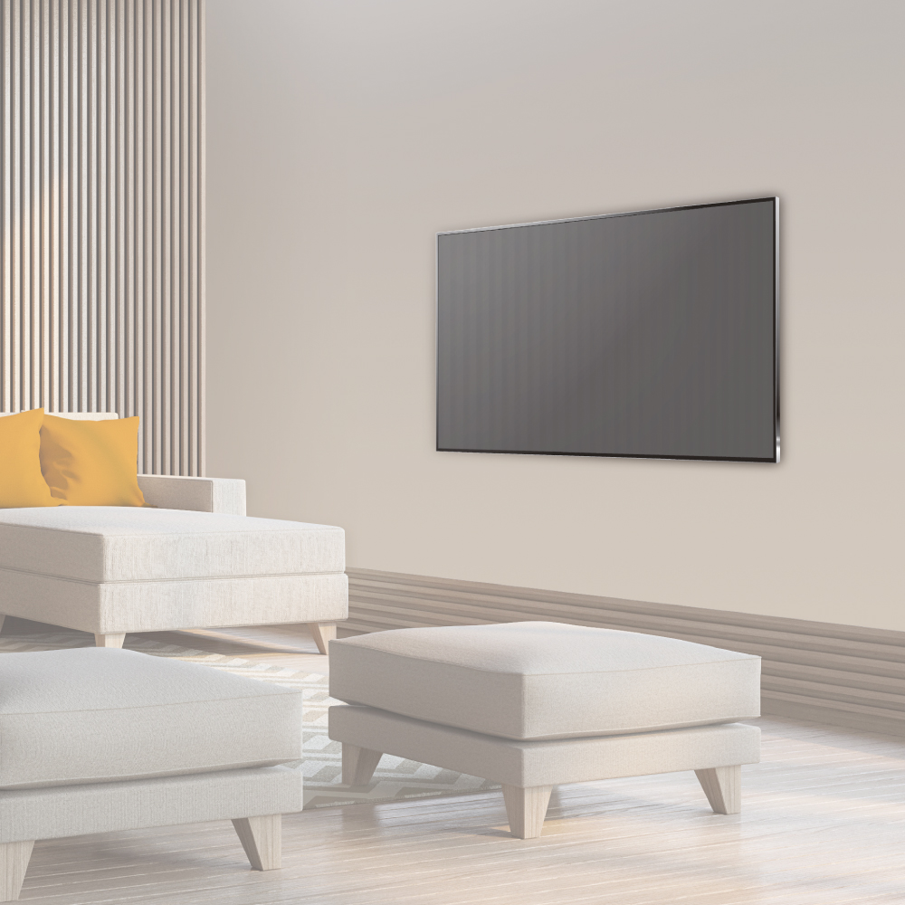 Living room with a TV mounted on the wall, a sofa and two ottomans, and a sunny window.