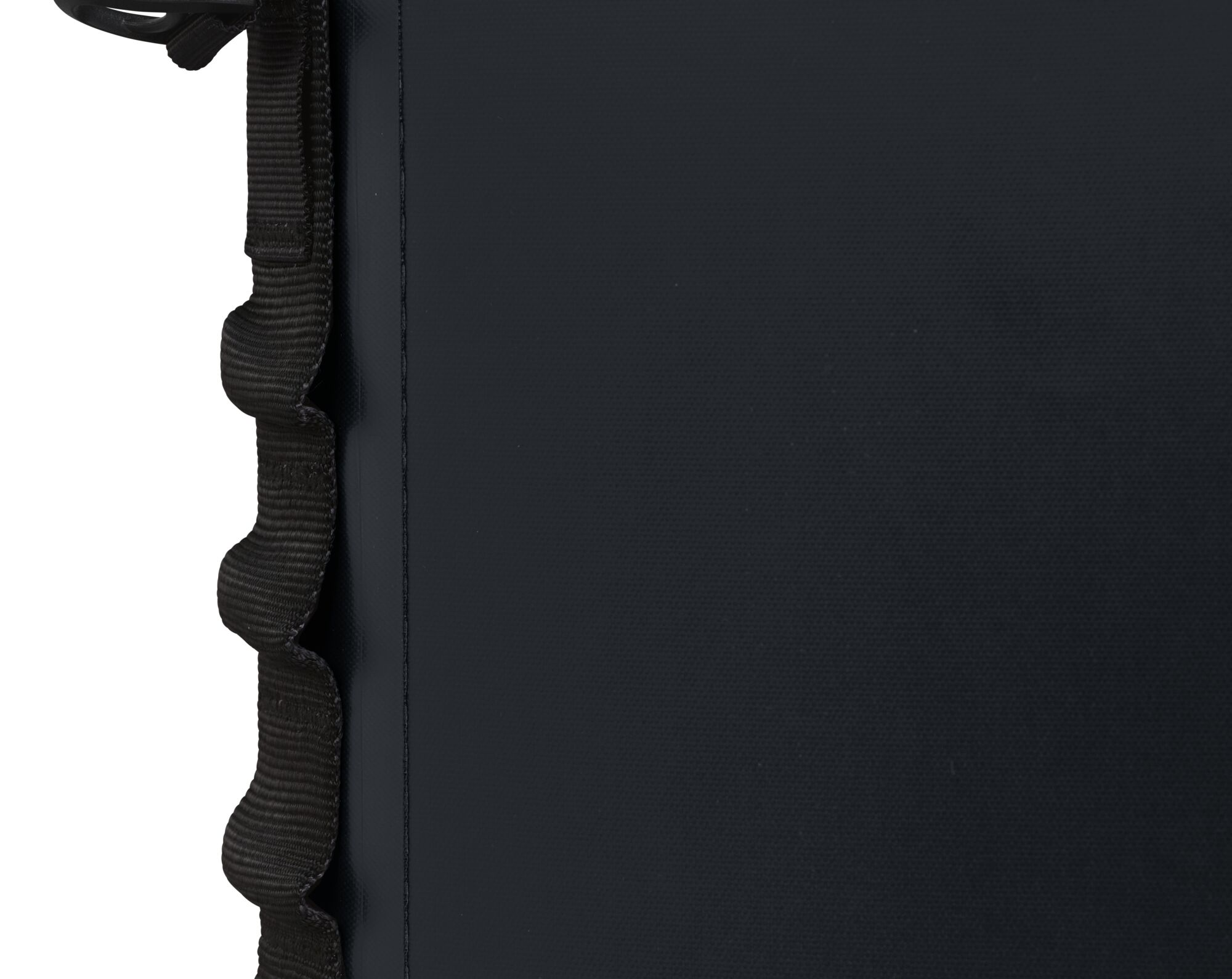 Black bag detail with a black shoulder strap and a textured surface.