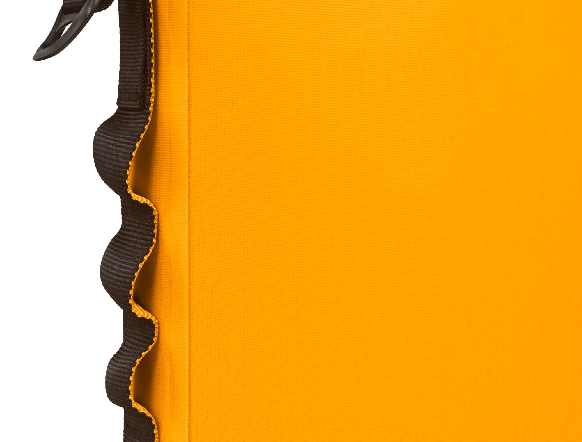 Close-up of a yellow fabric with a black wavy edge and a black strap.