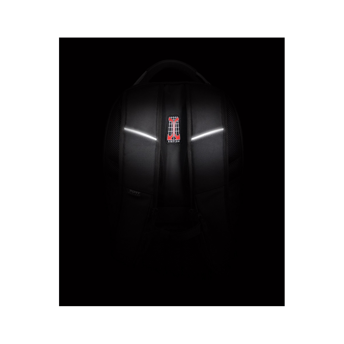 Black backpack with reflective stripes and a red logo in the dark.