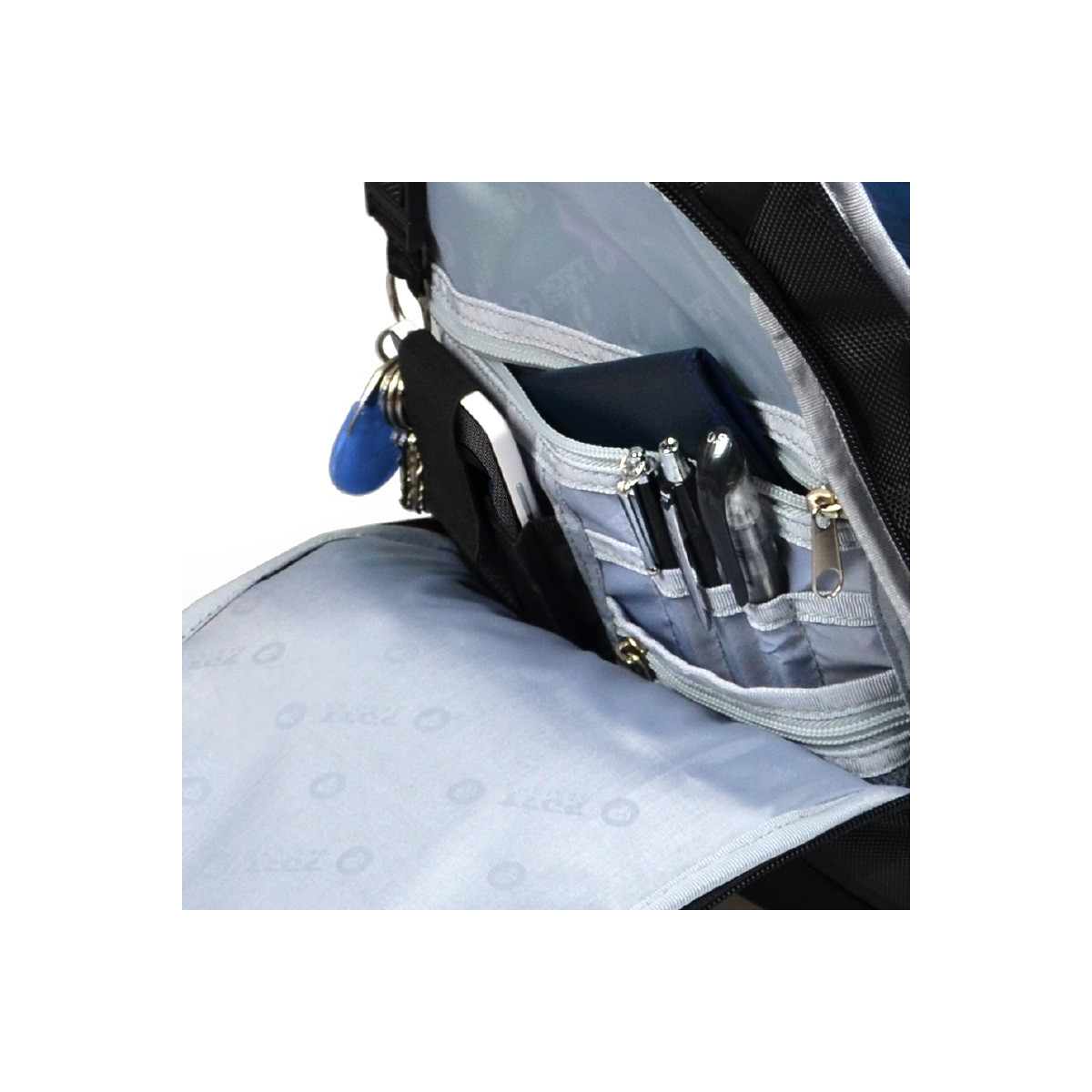 A close-up of a backpack's inside pockets with pens and keys visible.