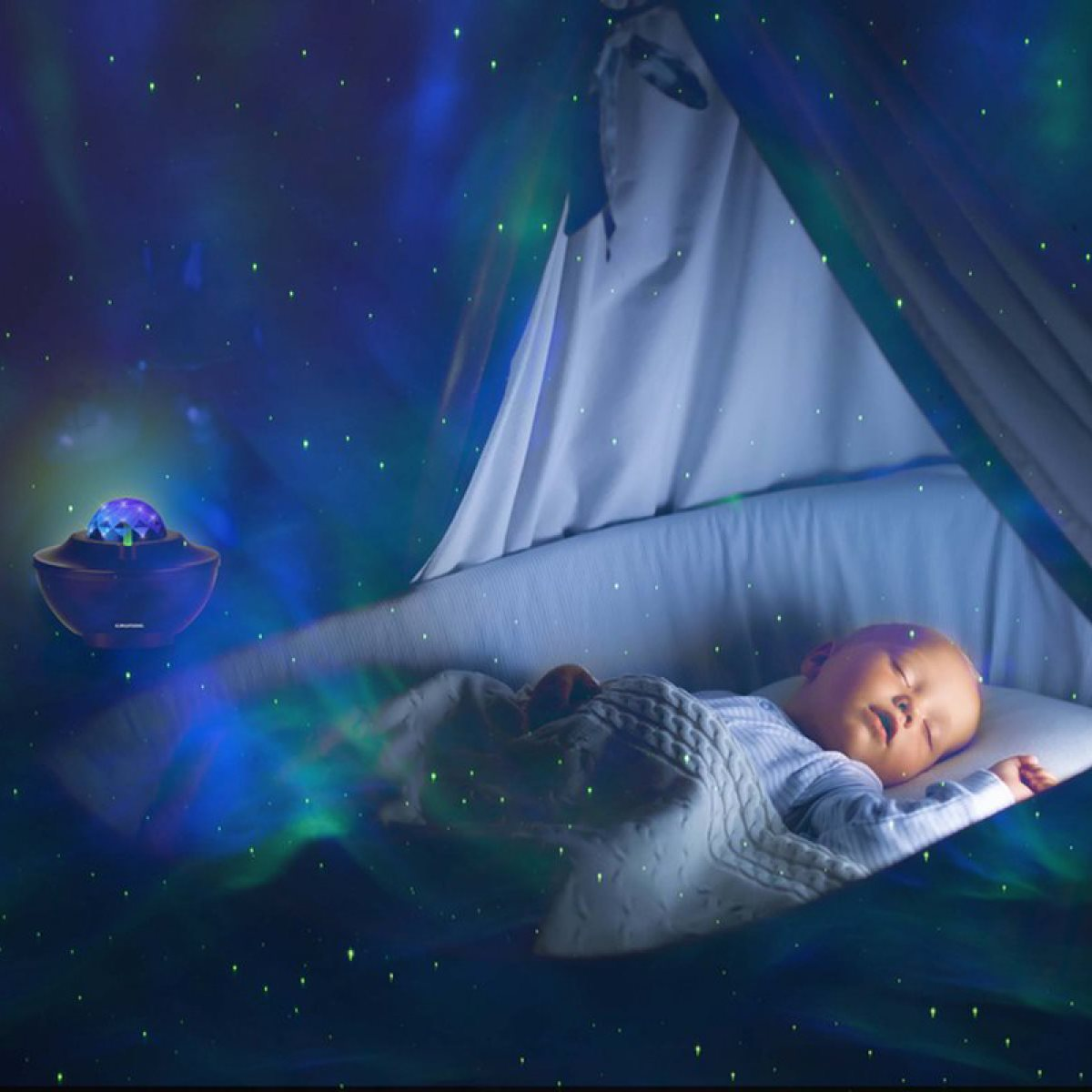 A baby sleeping in a crib under a starry night light projector.