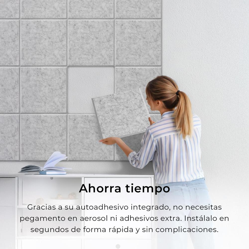 Mujer instalando paneles grises insonorizantes en una pared blanca. Gabinete blanco abajo.