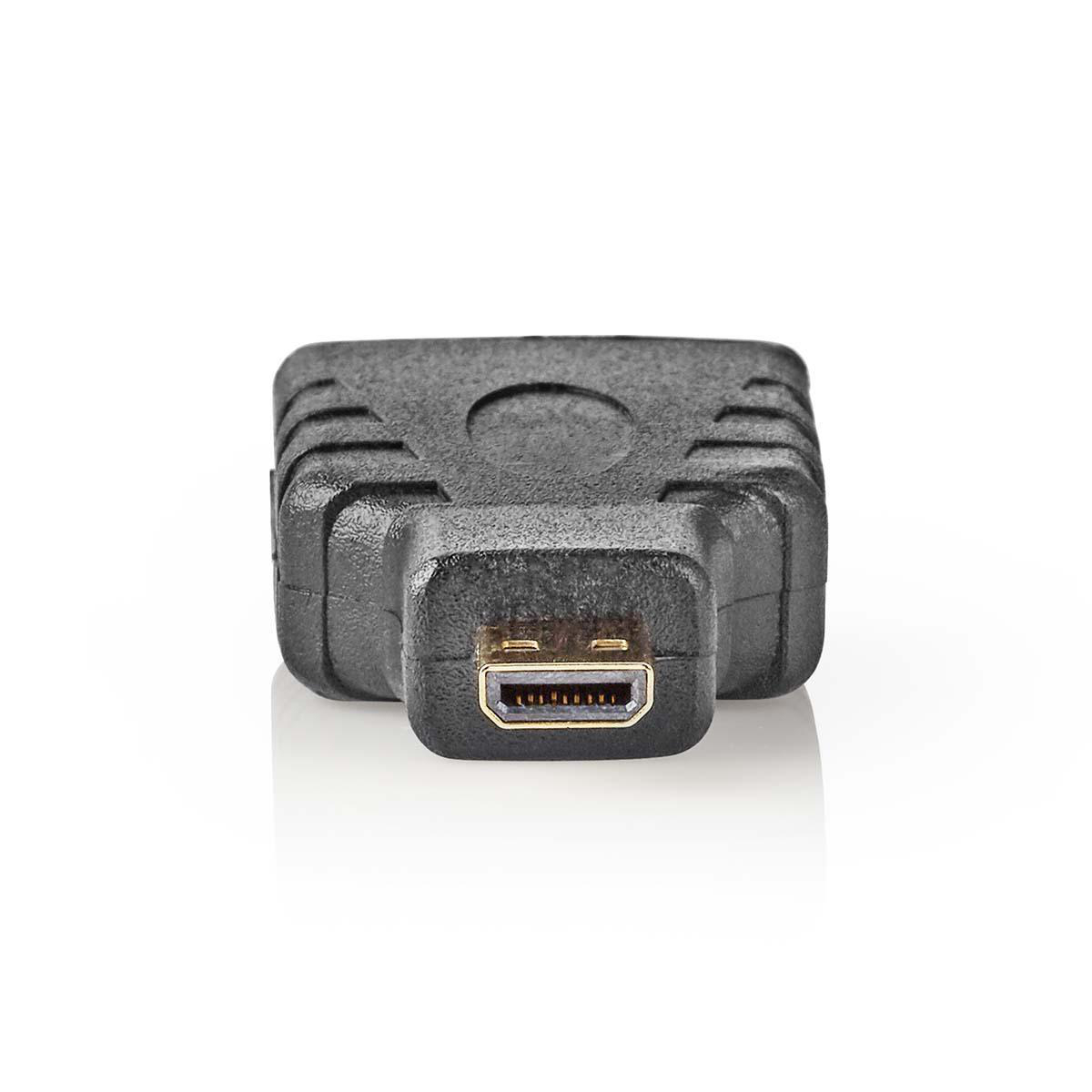Un adattatore HDMI nero su una superficie bianca, visto dall'alto.