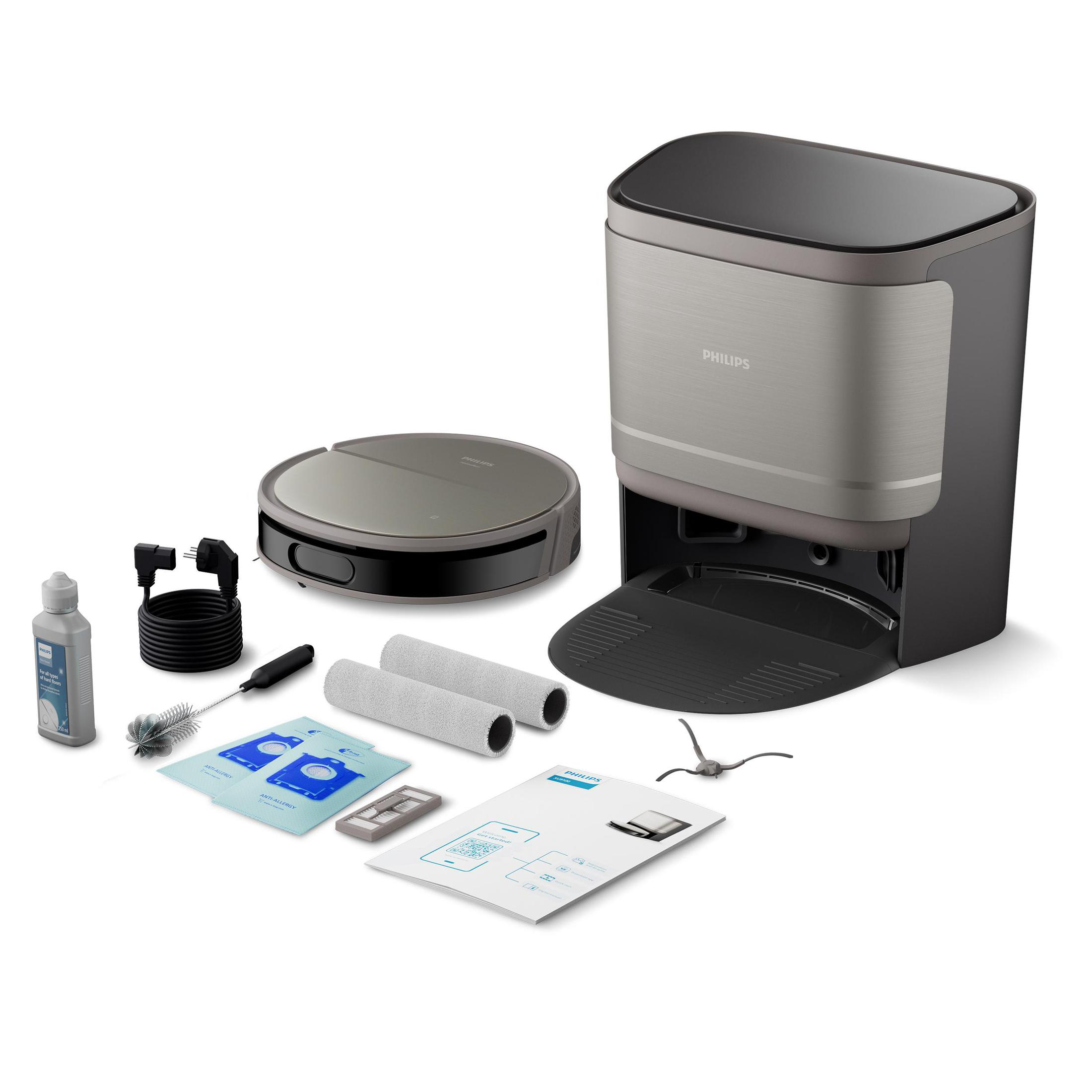 Robot sprzątający i stacja czyszcząca z akcesoriami: szczotką, chusteczkami, butelką i instrukcją.