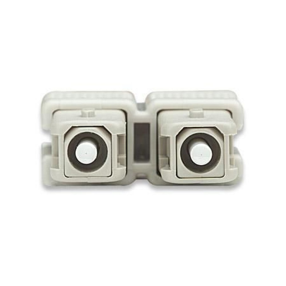 Due connettori in fibra ottica affiancati. I connettori sono beige e hanno centri bianchi.