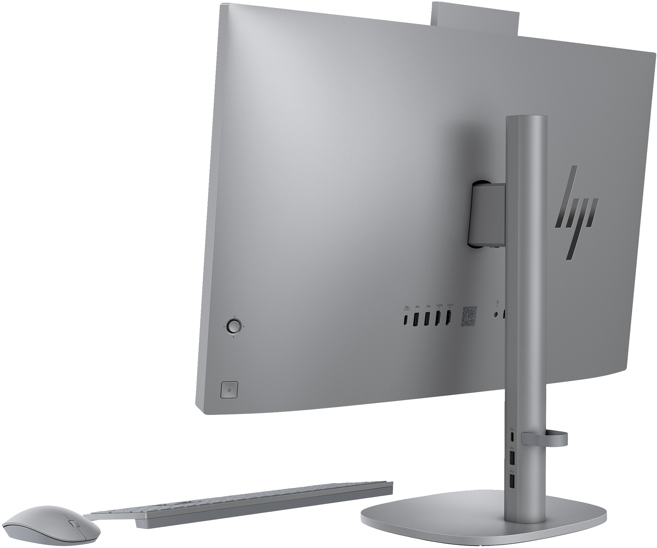Widok z tyłu srebrnego komputera HP all-in-one z klawiaturą, myszą i monitorem.