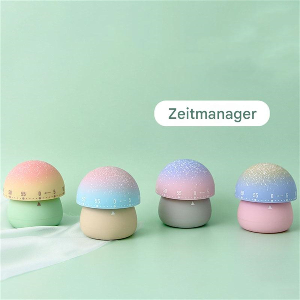 Vier pilzförmige Küchentimer in verschiedenen Farben, mit dem Wort 'Zeitmanager'.