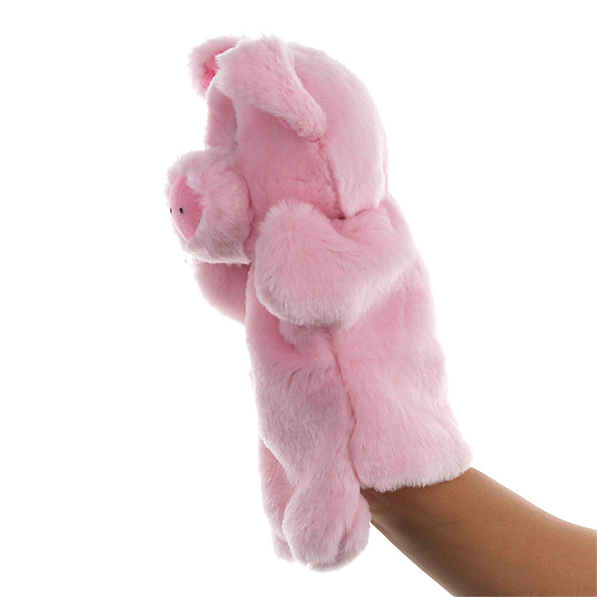 Eine rosa Schweinepuppe. Die Puppe ist flauschig und wird von einer Hand gehalten.