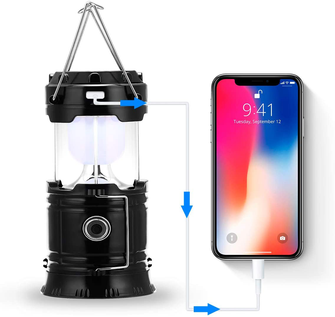 Schwarze Laterne, die ein Telefon auflädt. Weißer Hintergrund.
