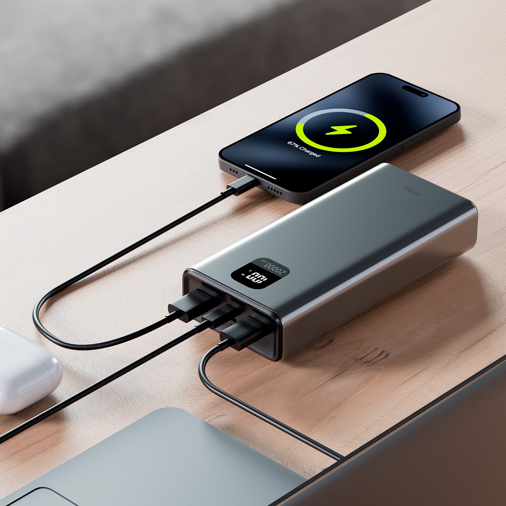 Telefon ładuje się z power banku. Telefon pokazuje 67% naładowania. Inne urządzenie też się ładuje.