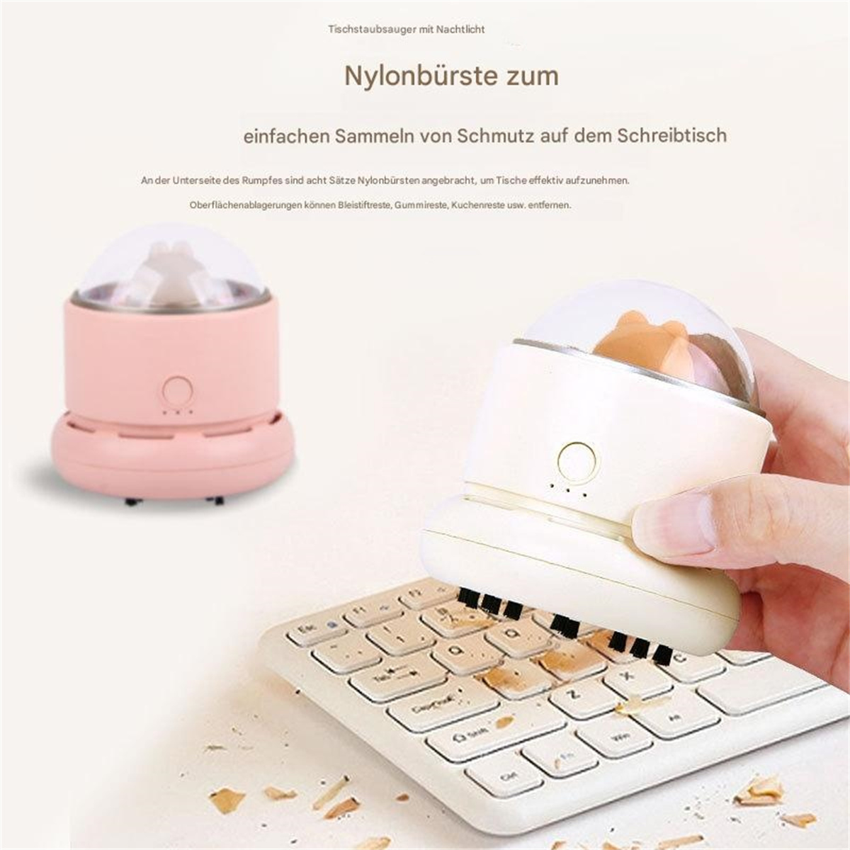 Ein kleiner rosa und weißer Tischstaubsauger, der eine weiße Tastatur reinigt.