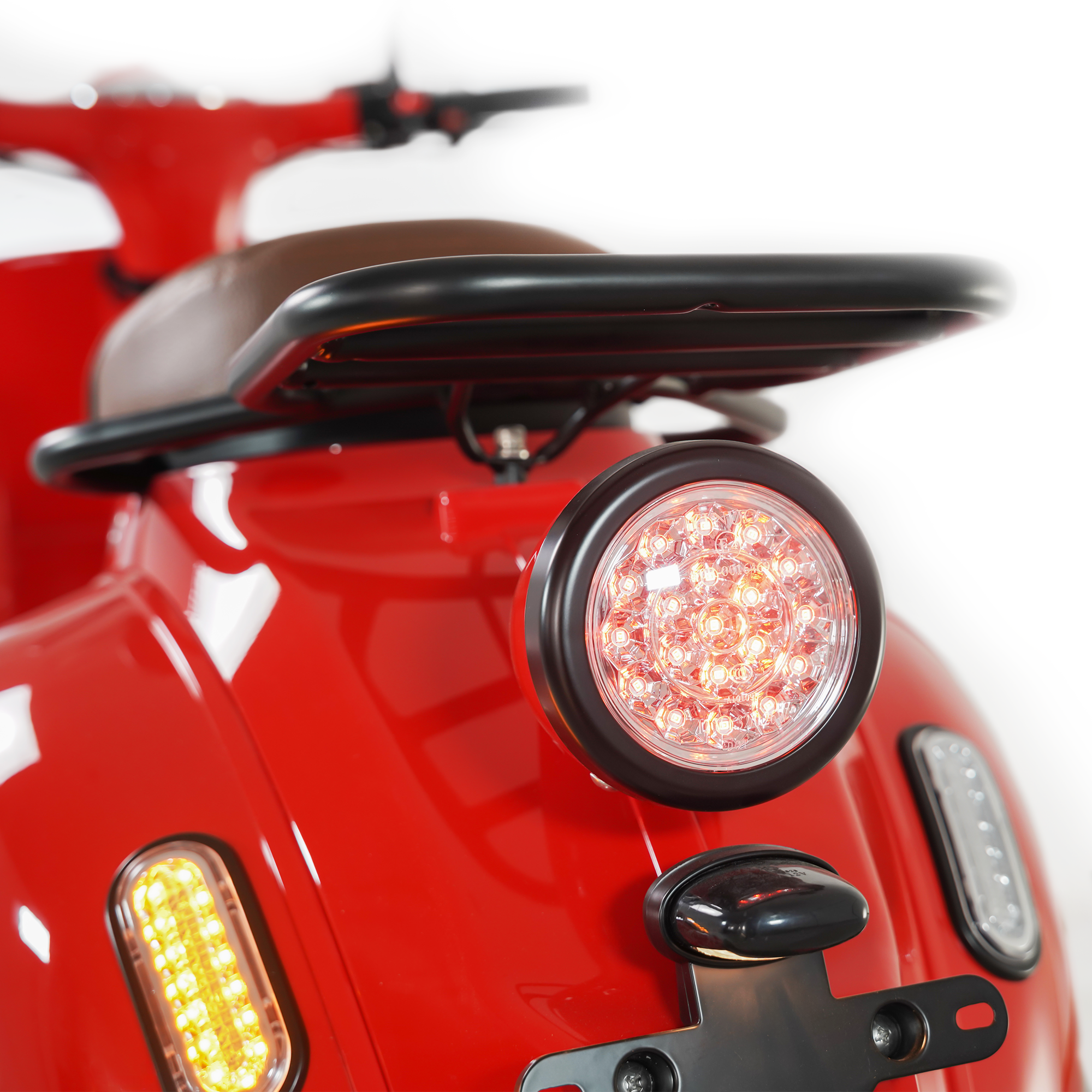 Rückansicht eines roten Rollers, die Rückleuchte und Blinker zeigend. Weißer Hintergrund.
