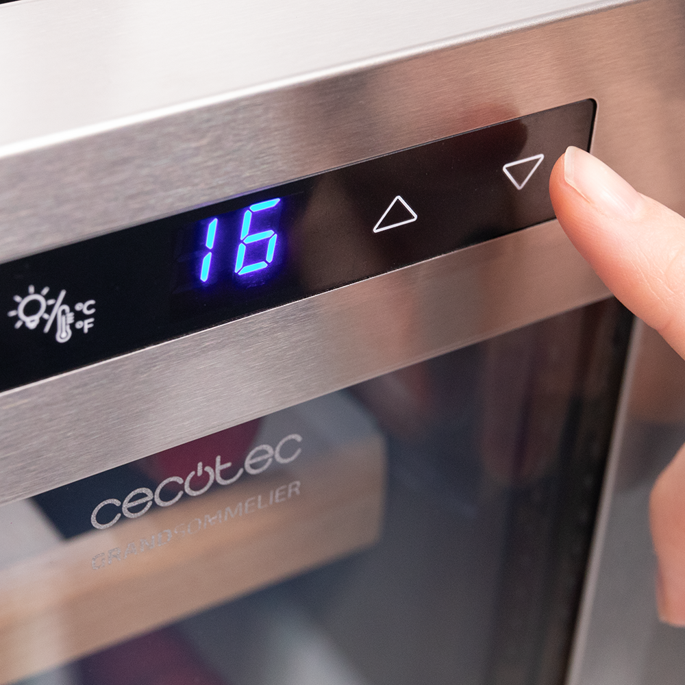 A hand touching a digital display showing '16' on a CECotec device. The display has up and down arrows.