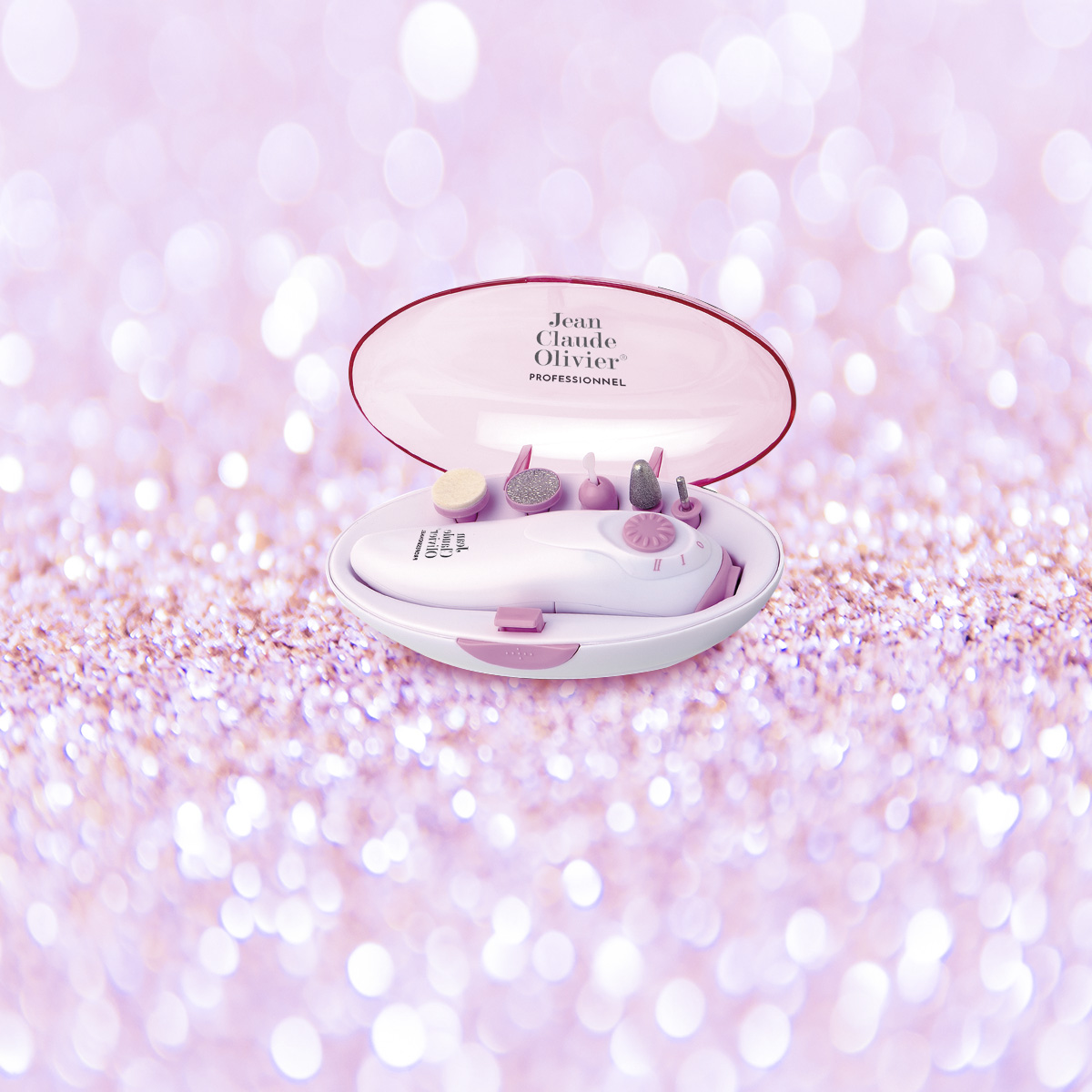 White and pink nail care kit with accessories inside an open case on a pink glitter background.