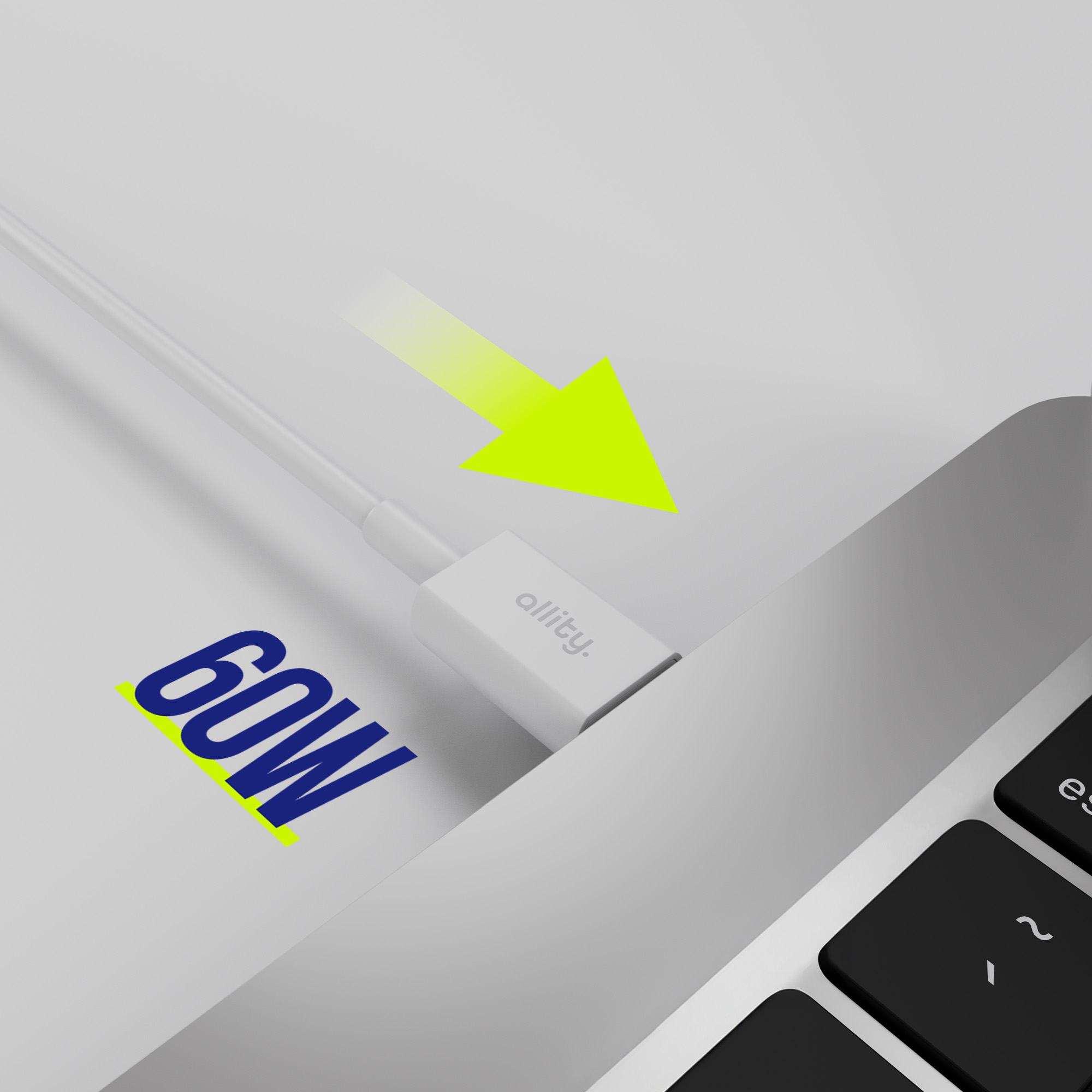 Port laptopa jest podłączany przez białą ładowarkę z napisem '60W'.