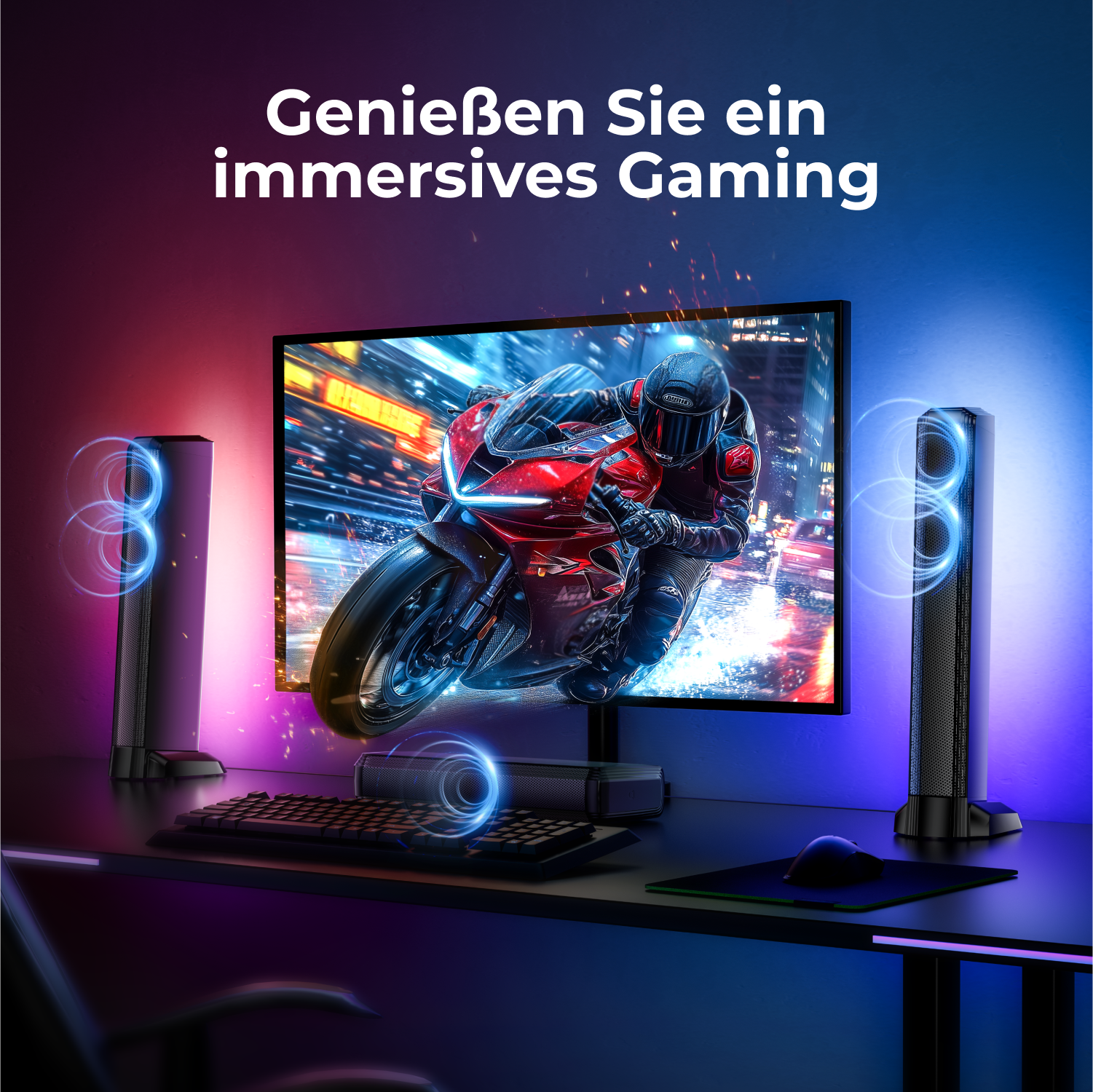 Ein Gaming-Setup mit Monitor, Lautsprechern, Tastatur und Maus auf einem schwarzen Schreibtisch.