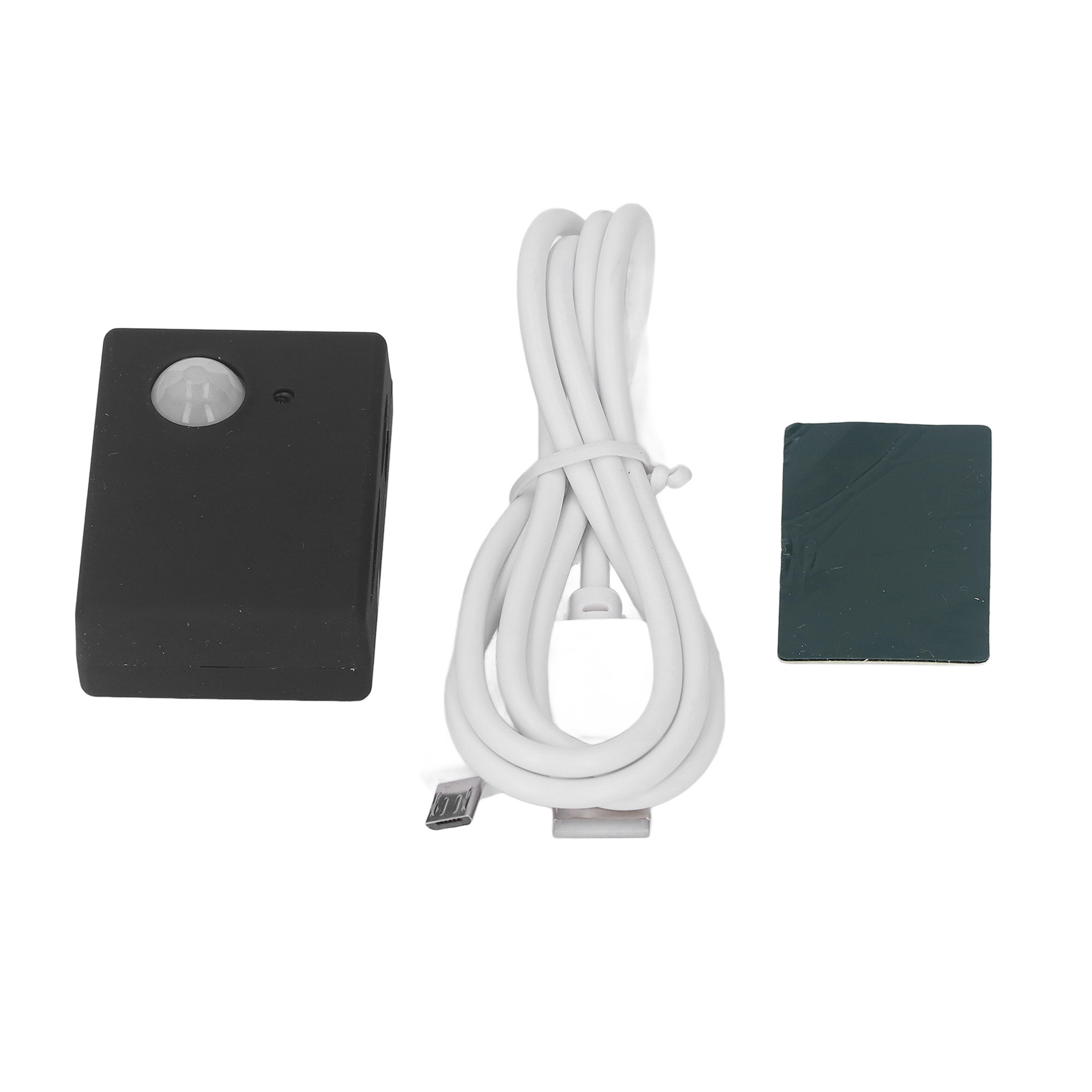 Schwarzes Gerät mit Bewegungssensor und weißem USB-Kabel. Ein quadratisches Klebepad ist ebenfalls sichtbar.