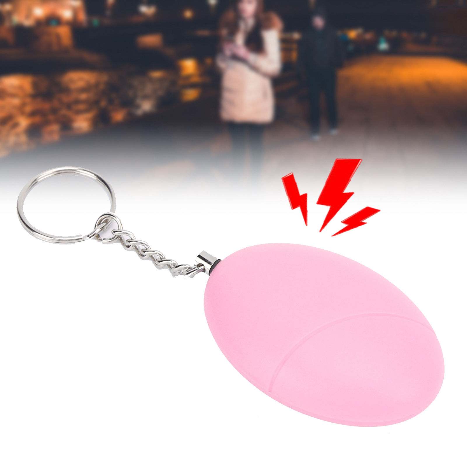 Ein pinkfarbener persönlicher Alarm mit Schlüsselanhänger. Es wird mit einem verschwommenen Hintergrund gezeigt.