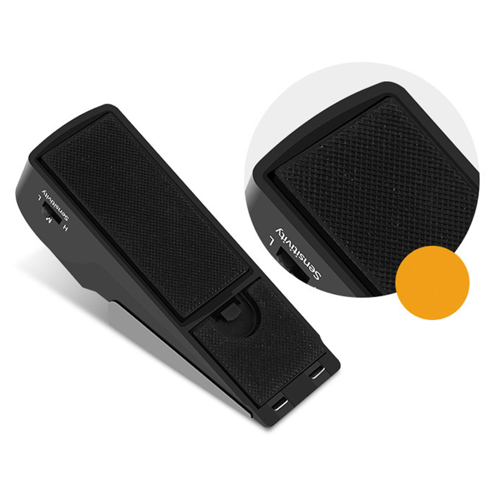 Ein schwarzer Türstopper mit einem Schalter für hohe/niedrige Empfindlichkeit. Hat eine Gummigriff-Oberfläche und einen orangefarbenen Kreis im Hintergrund.