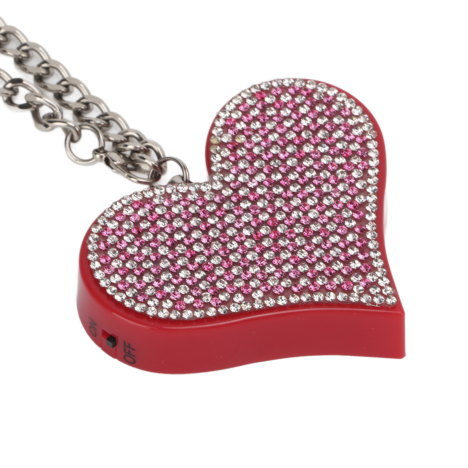 Rotes herzförmiges Gerät mit glänzenden Steinen. Eine Kette ist befestigt.