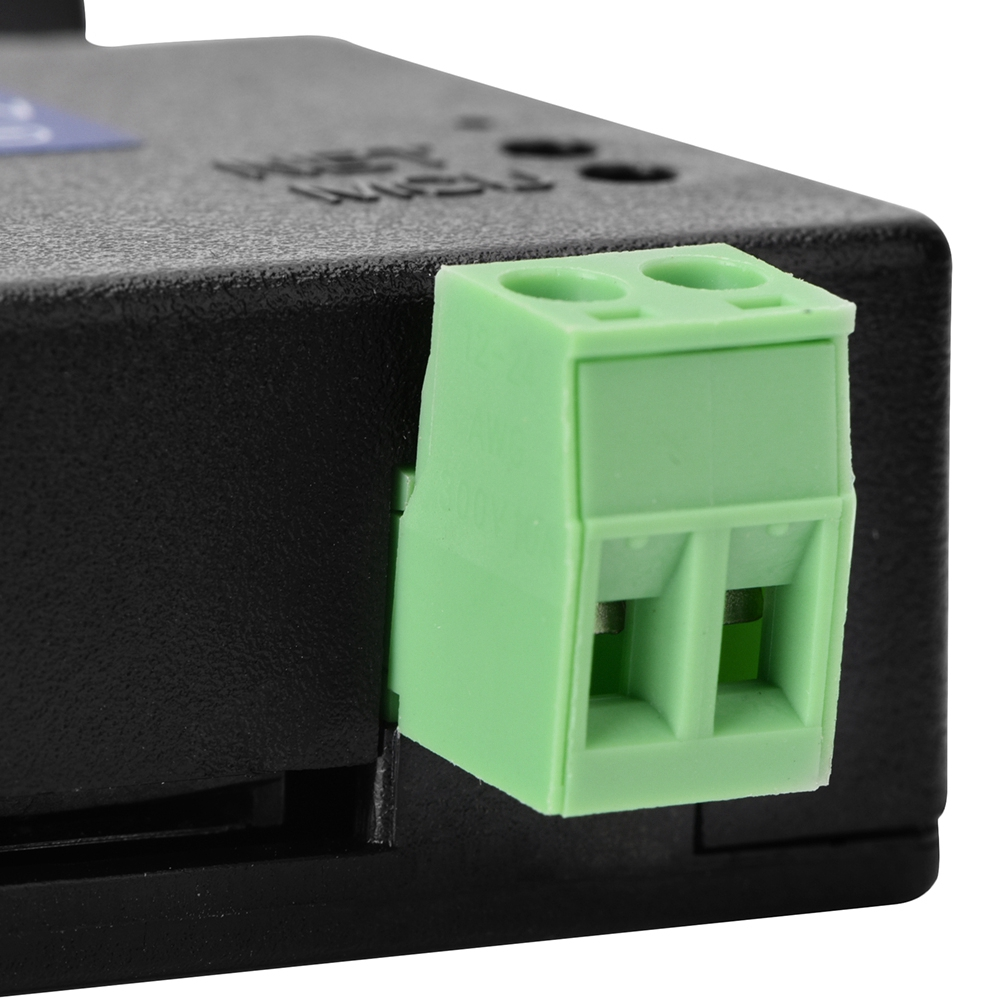 Nahaufnahme eines grünen Steckers an einer schwarzen Box. Der Stecker hat zwei Löcher.