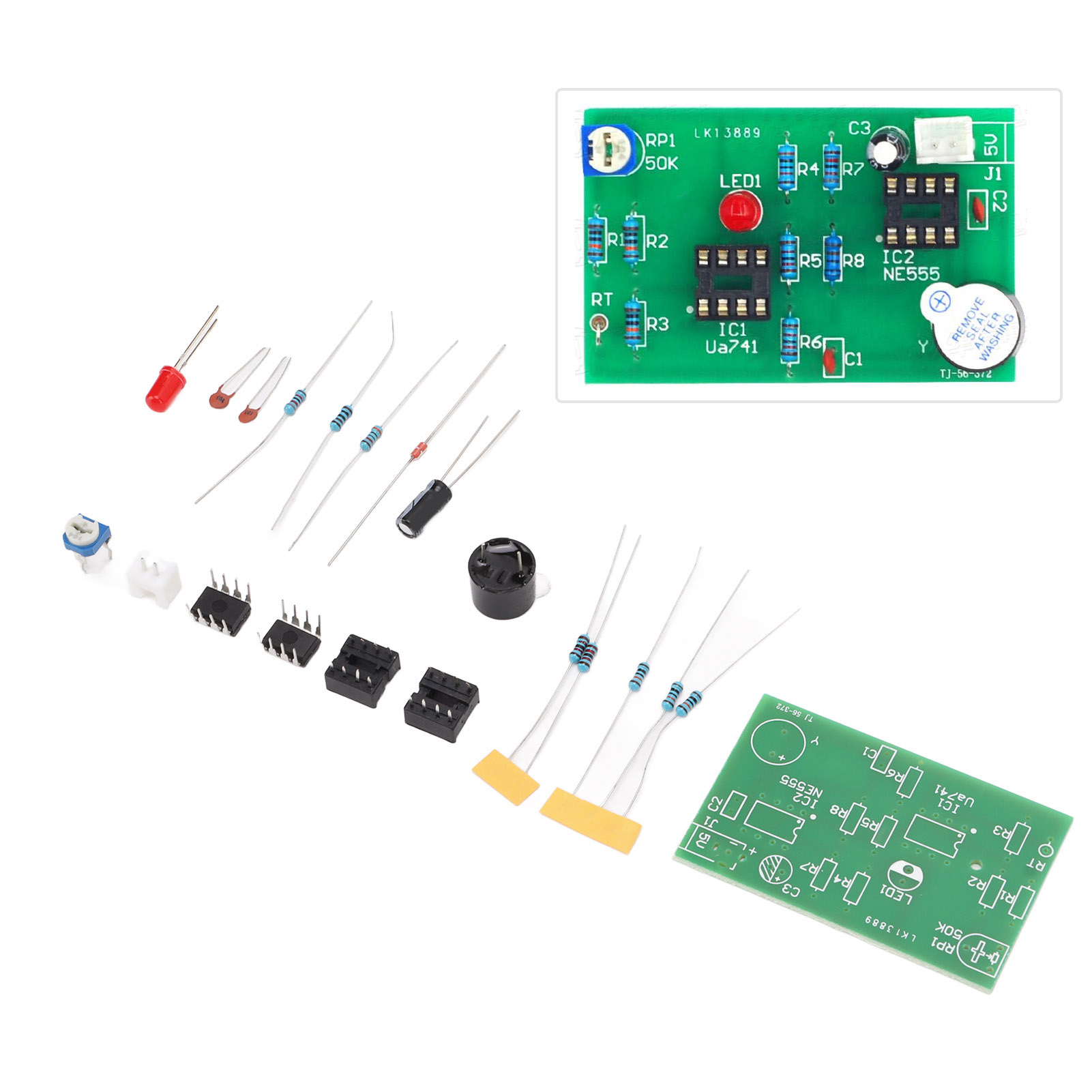 Elektronische Komponenten auf einem Tisch angeordnet, darunter eine Leiterplatte, Widerstände und Kondensatoren.
