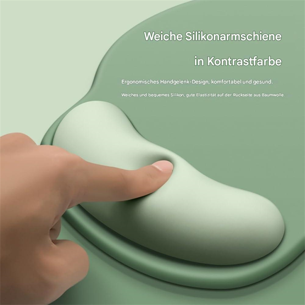 Hand berührt ein grünes ergonomisches Mousepad mit gepolstertem Bereich, Text auf Deutsch.