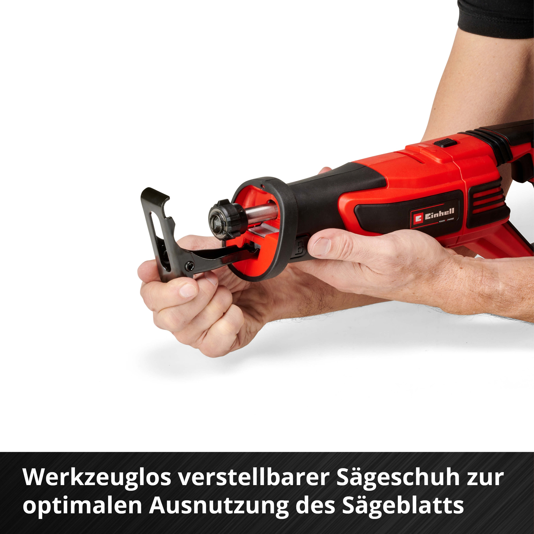 A red and black saw with a hand holding it, white background.