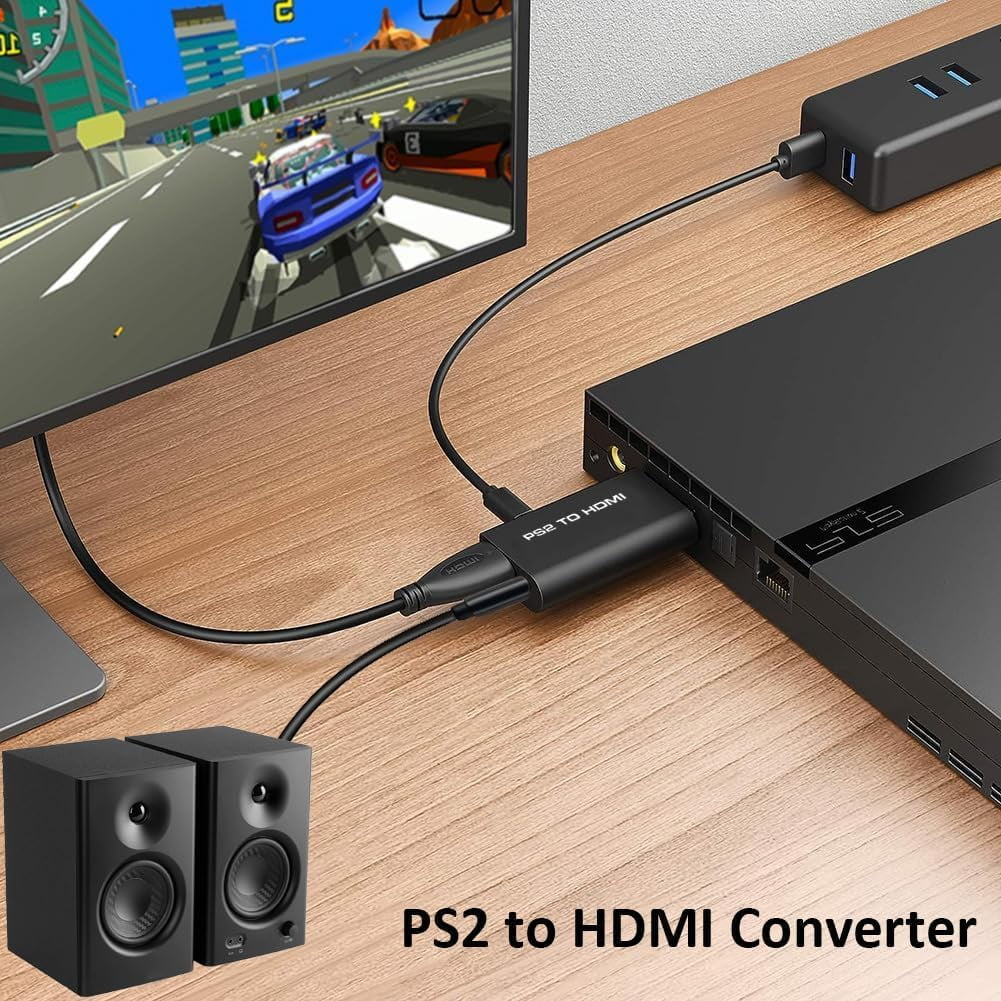 Ein PS2-zu-HDMI-Konverter, der an eine PS4, einen Monitor und Lautsprecher auf einem Holztisch angeschlossen ist.