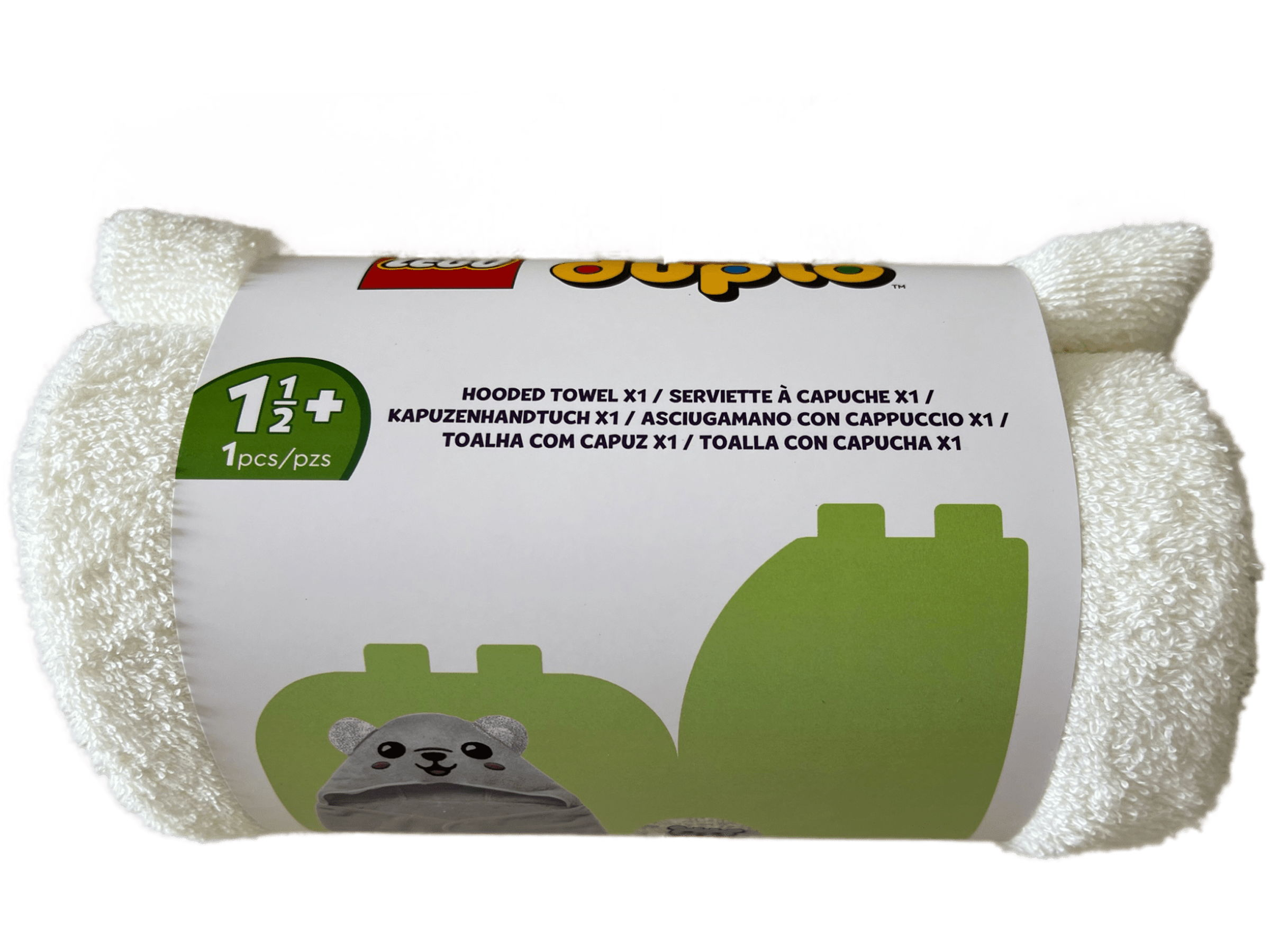Une serviette à capuche Lego Duplo blanche, enroulée, avec un emballage montrant un ours et du texte.