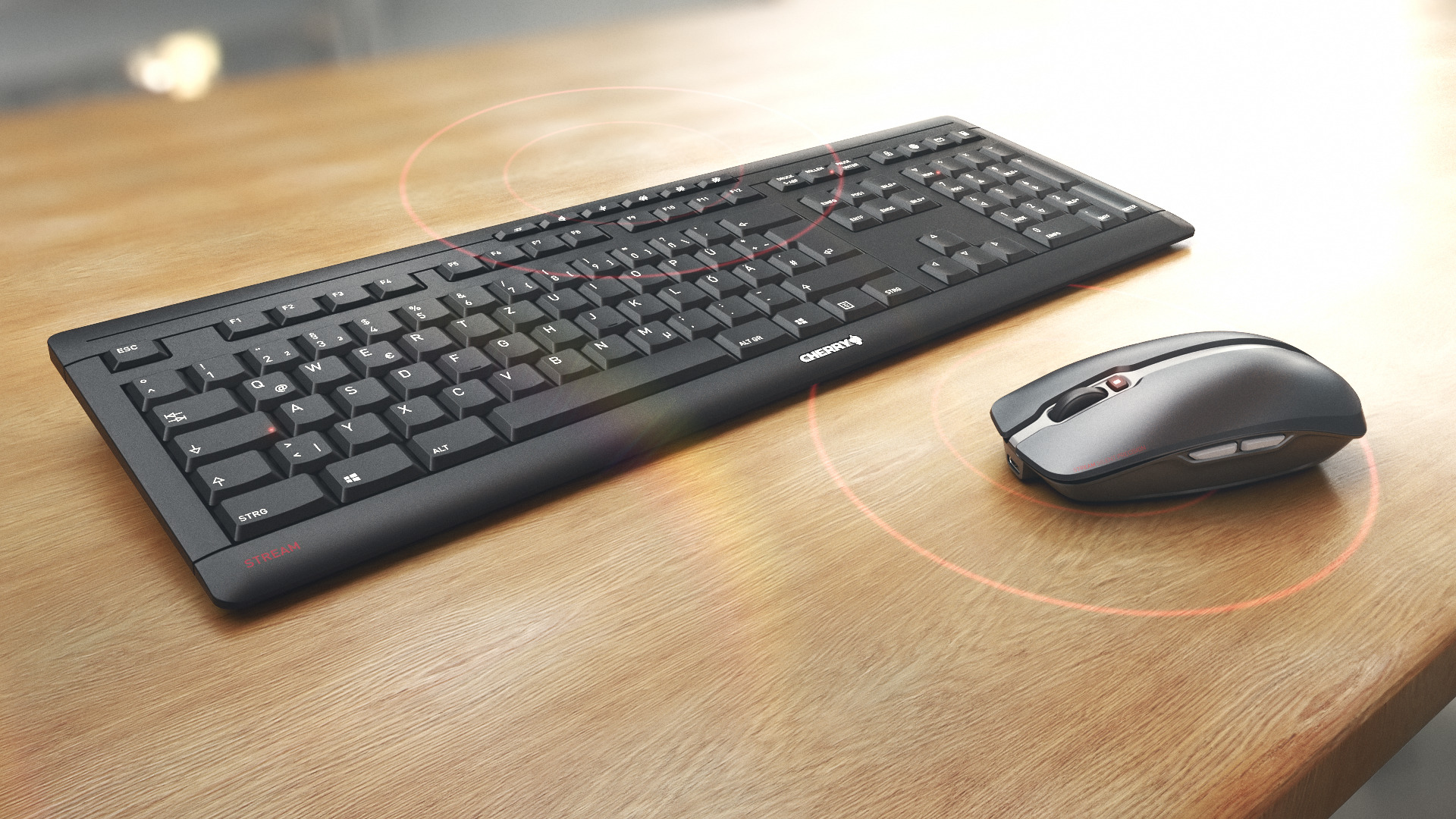Un teclado y ratón Cherry negros sobre un escritorio de madera, con círculos rojos alrededor.