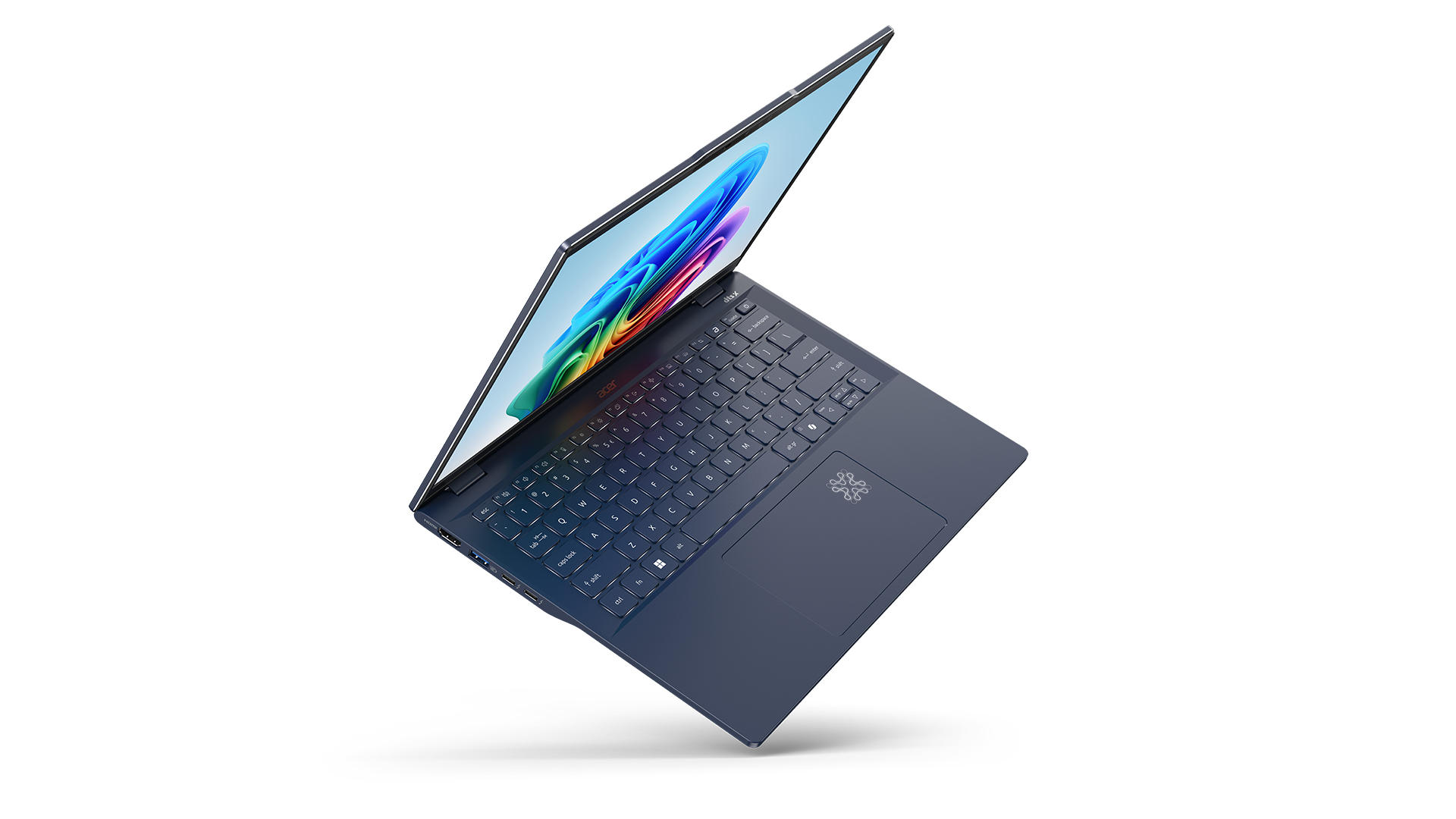 Ciemnoniebieski laptop, otwarty, pokazujący klawiaturę i ekran z kolorową grafiką.
