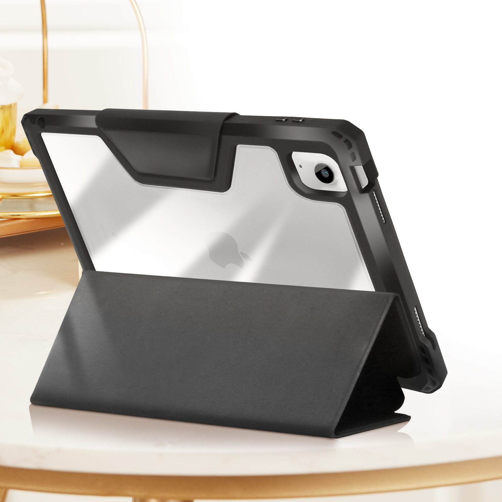 Custodia per tablet nera. Schienale trasparente, supporto nero. Su un tavolo bianco.