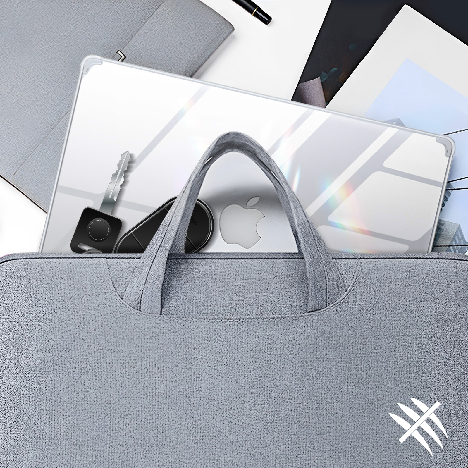 Portátil en una bolsa gris con llaves y un mando. El logotipo de Apple es visible.