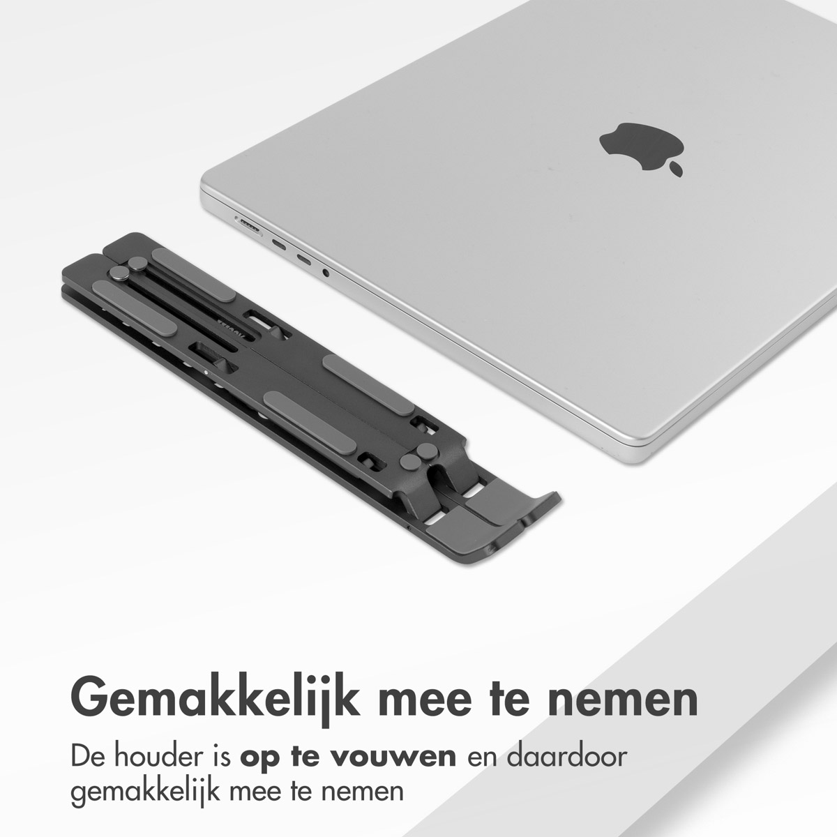 A black laptop stand and a silver laptop are next to each other. The stand is foldable.