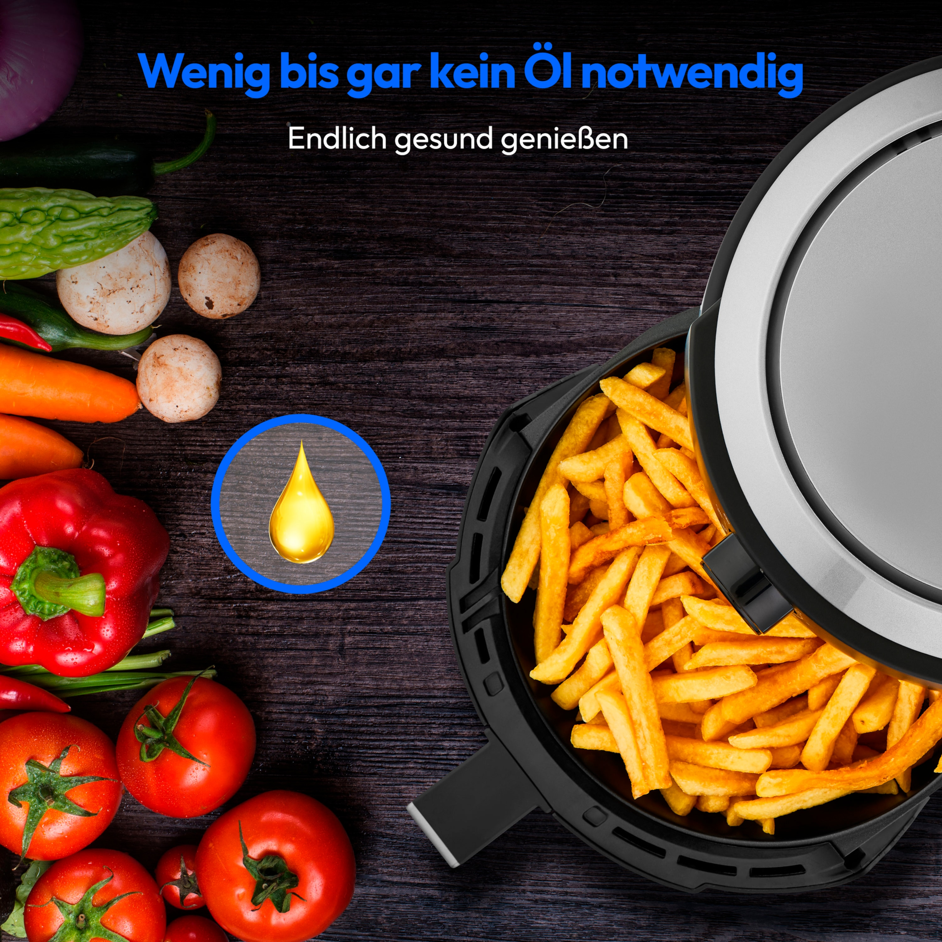 Een airfryer met frietjes erin en een druppel olie. Rode paprika en tomaten op tafel.