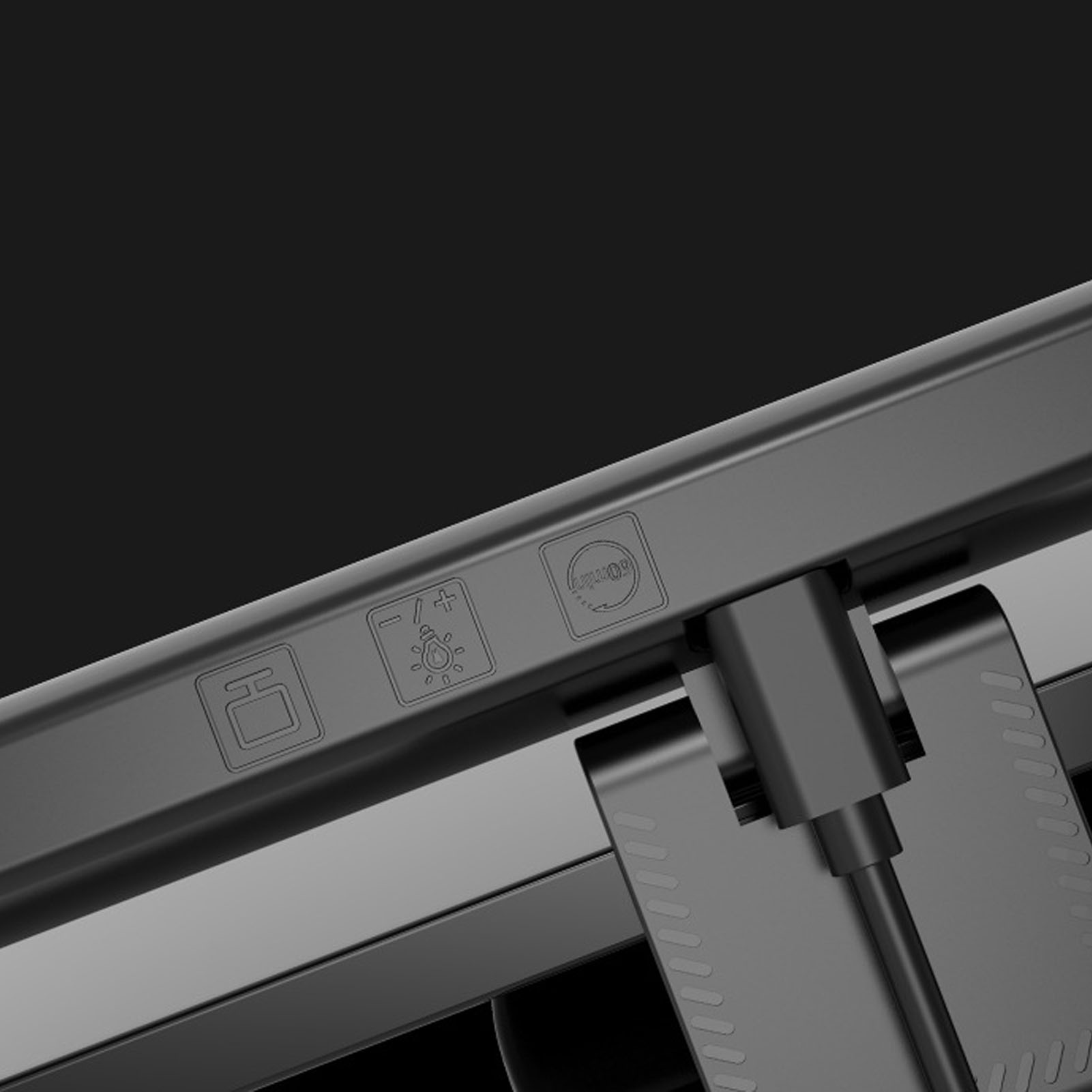 Nahaufnahme eines schwarzen Monitors mit Knöpfen und einem USB-C-Anschluss. Es hat einen dunklen Hintergrund.
