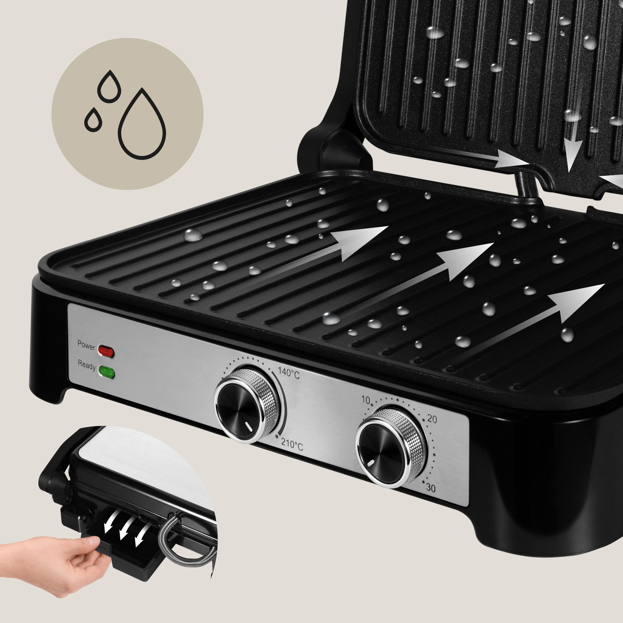 Zbliżenie czarnego grilla z kroplami wody, pokrętłami temperatury i lampką gotowości.