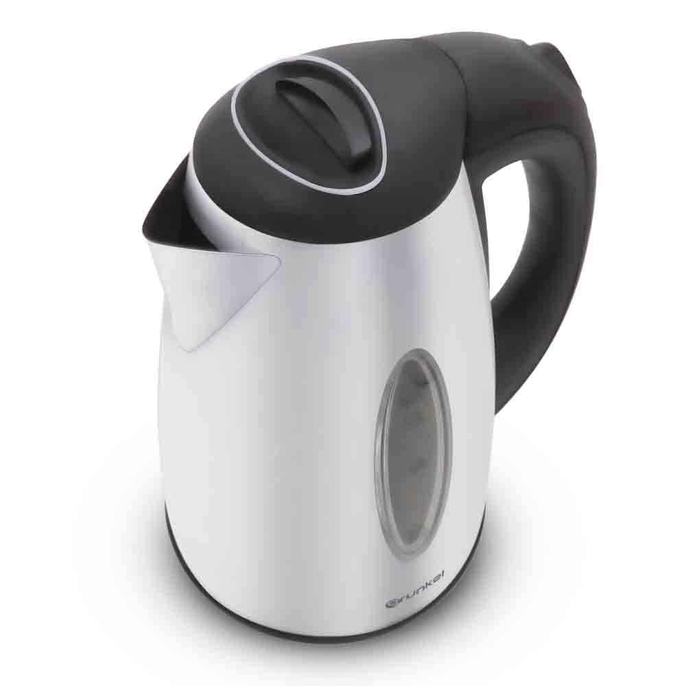 Una tetera eléctrica en una combinación de colores blanco y negro. Está sobre una superficie blanca.