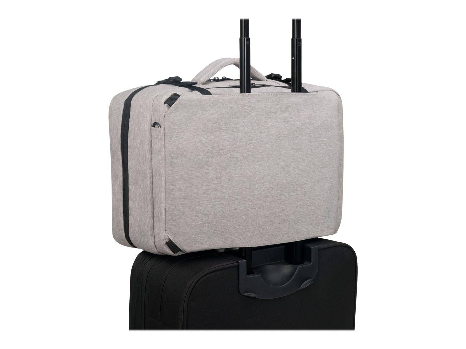 Valise grise au-dessus d'une valise noire. La valise grise a une poignée.
